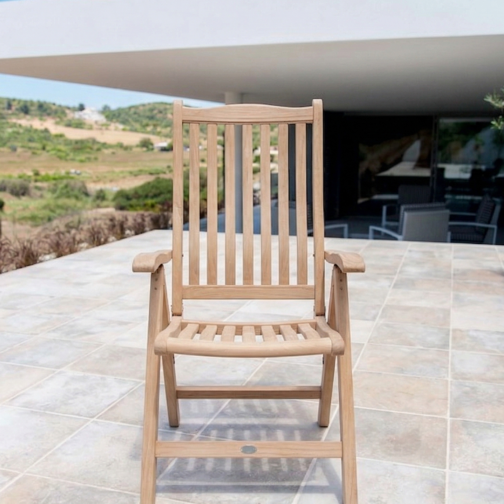 folding carver chair with slatted back and seat on a tiled patio