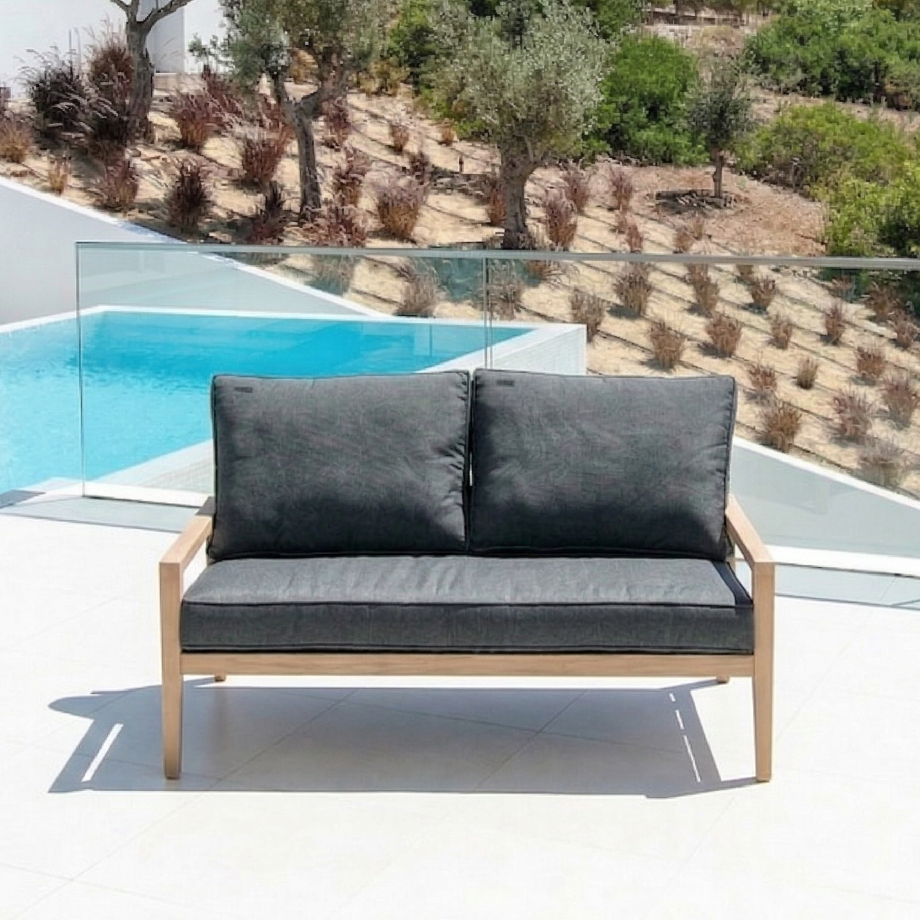 2-seater loung sofa with dark grey seat cushion and two rear cushions to match on a patio