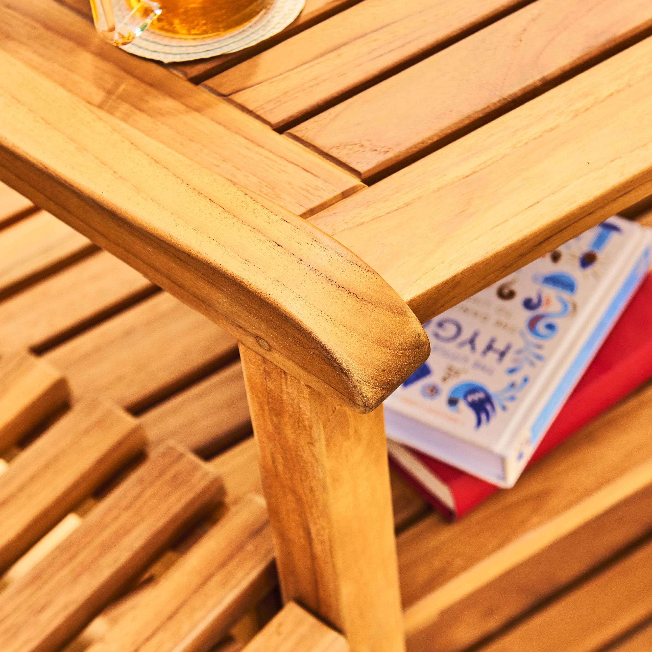 Wooden table with a book and a glass on top