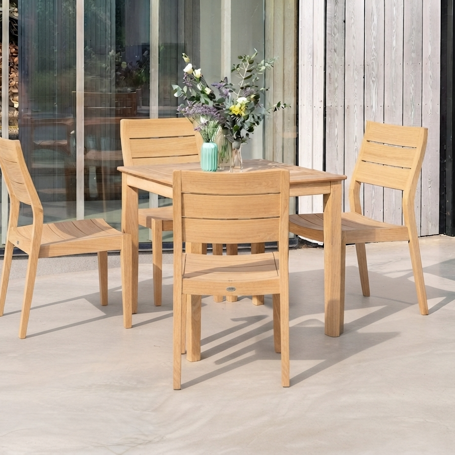 A 5-piece outdoor dining set consisting of a rectangular wooden table and four matching slatted chairs, styled on a concrete patio in front of a glass-walled patio room.