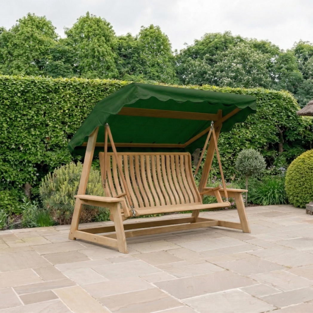 luxury wood swing seat with green canopy on a patio with hedge and green plants