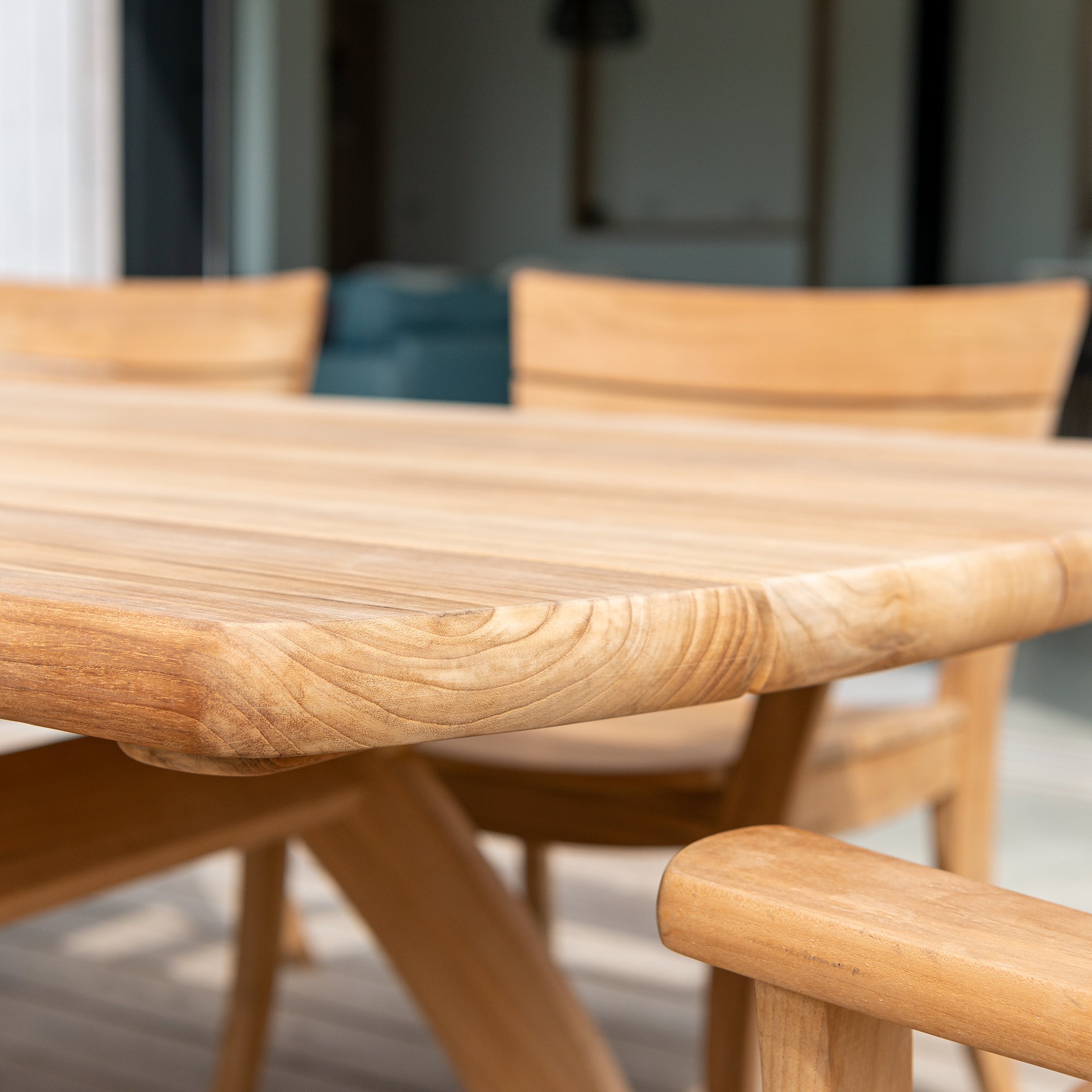 Wooden dining table with chairs in a blurred indoor setting