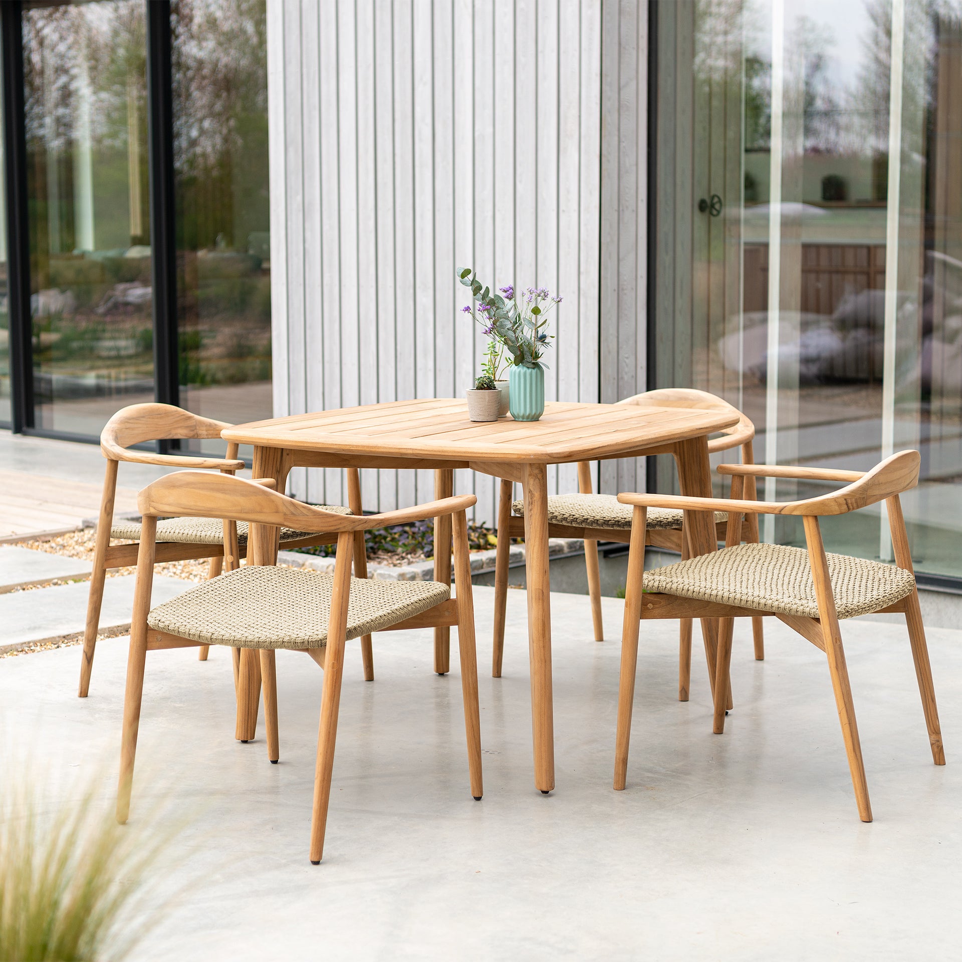 Alexander Rose Dana outdoor patio dining set with 4 rounded armchair dining chairs with woven seats