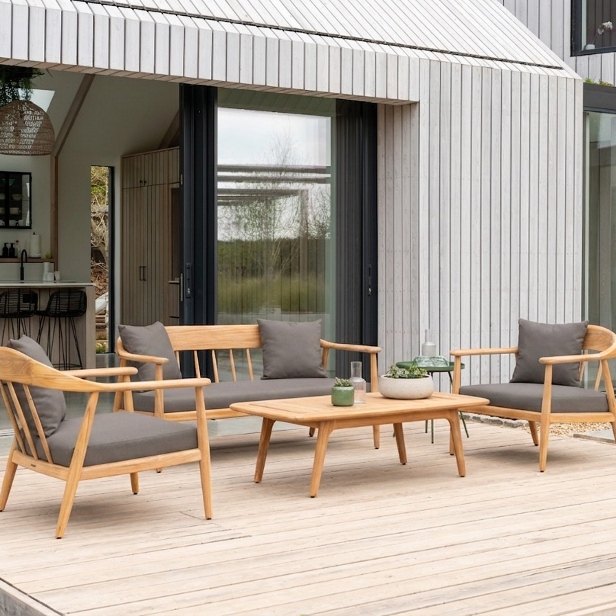 Scandinavian style outdoor patio set with sofa, two chairs all with curved arms and a coffee table