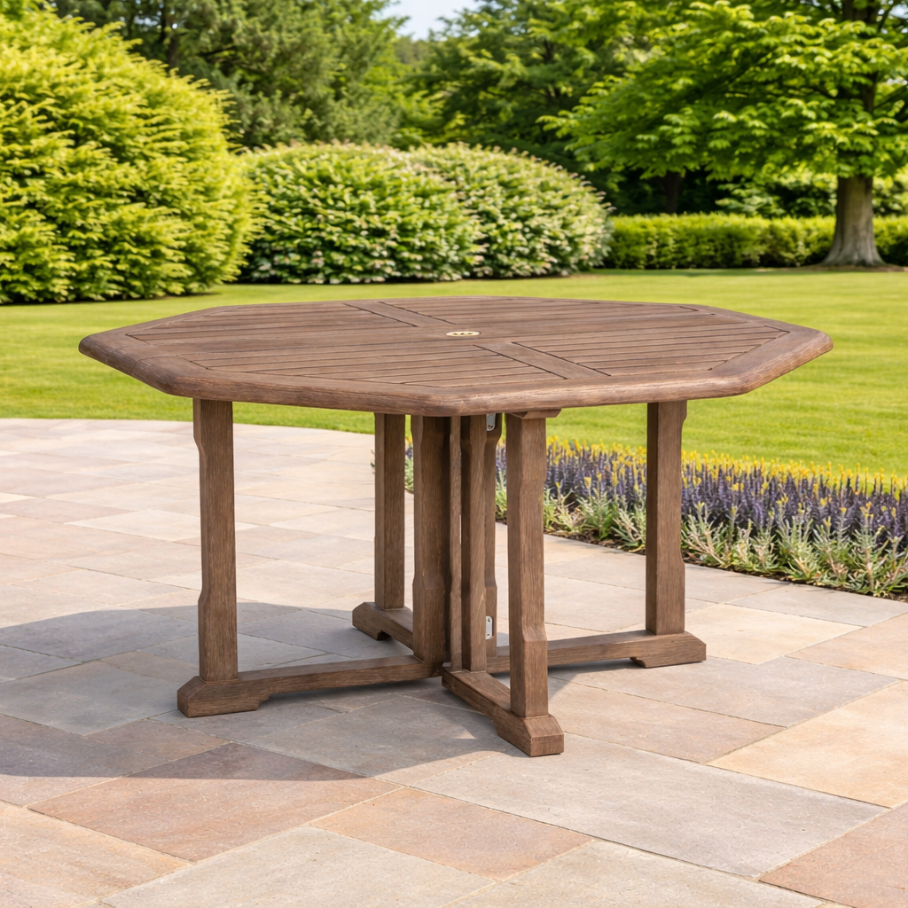 Wooden outdoor table on a patio with greenery in the background