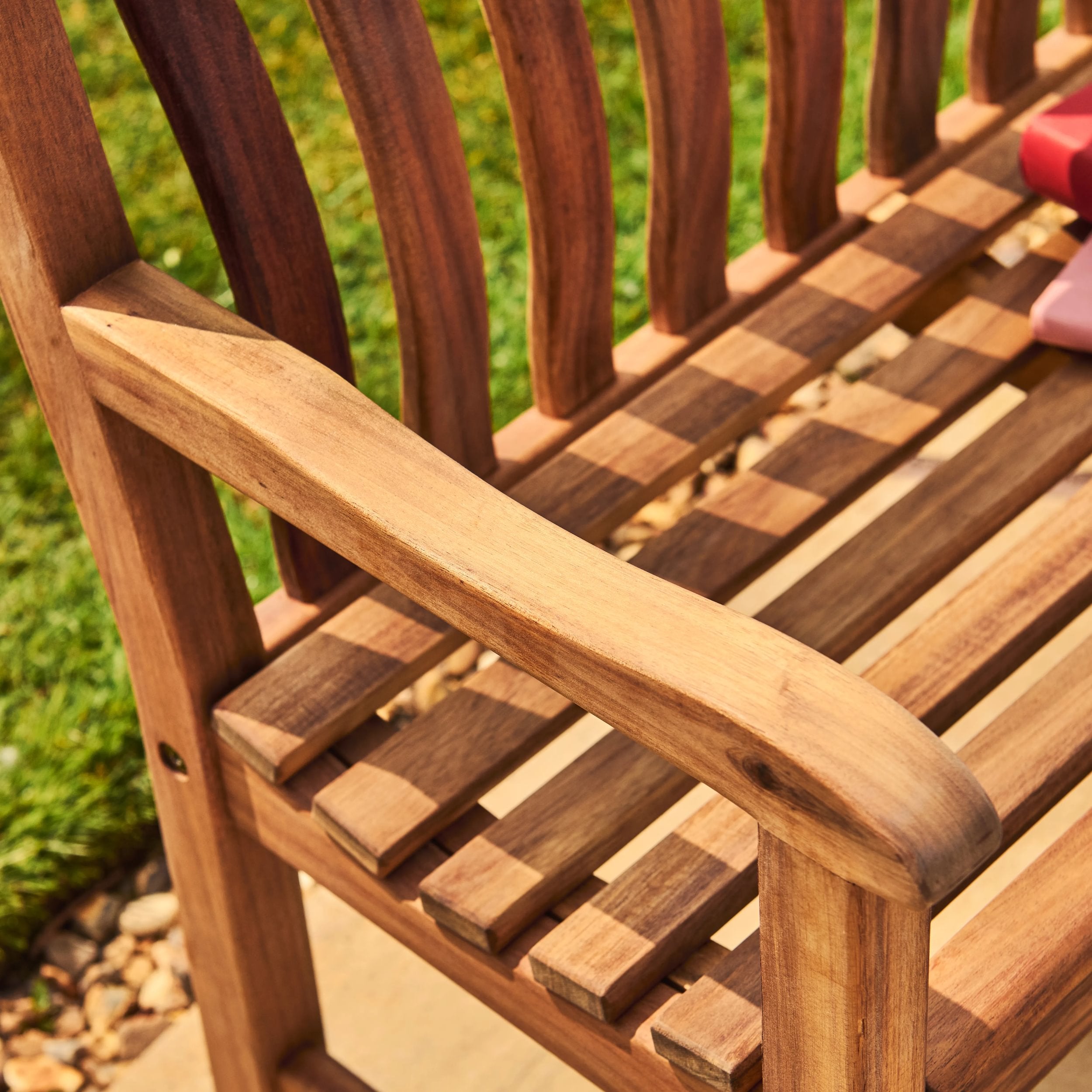 Close-up of a wooden bench on a blurred natural background