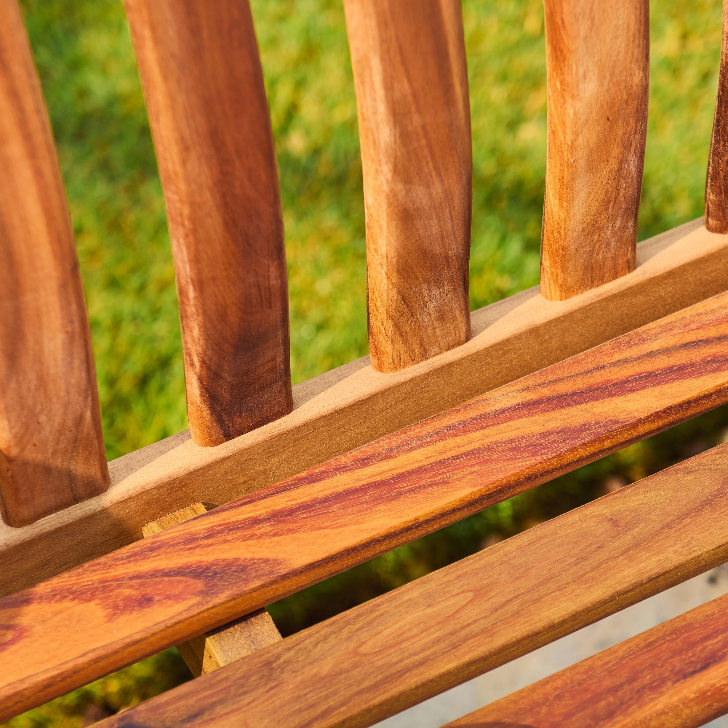 Close-up of wooden slats with a blurred green background