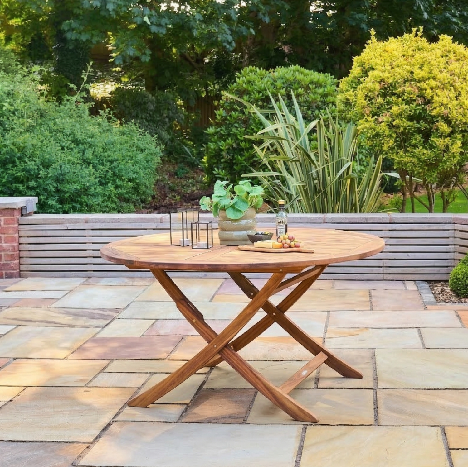 Wooden outdoor table with plants on a stone patio
