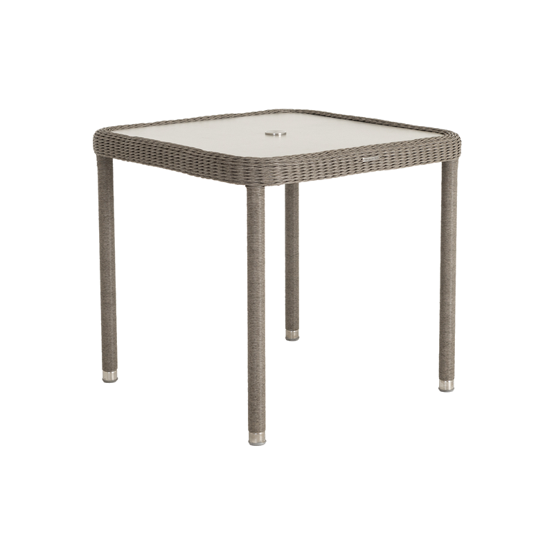 Square outdoor table with wicker frame and glass top on a white background