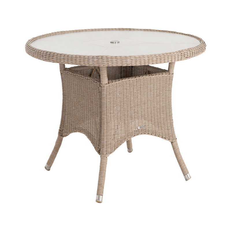 Round wicker table with a white glass top on a white background