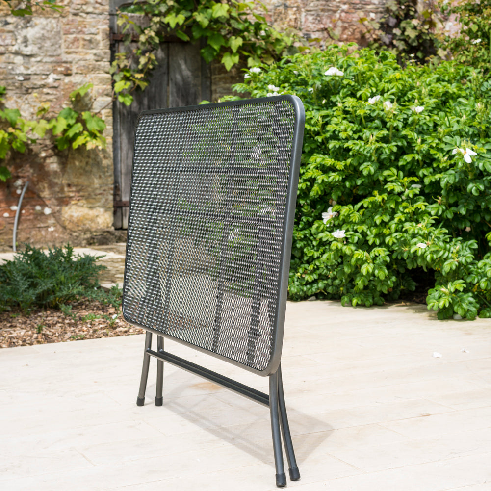 Portofino rectangular table in a folded position showing how compact this black mesh table can fold