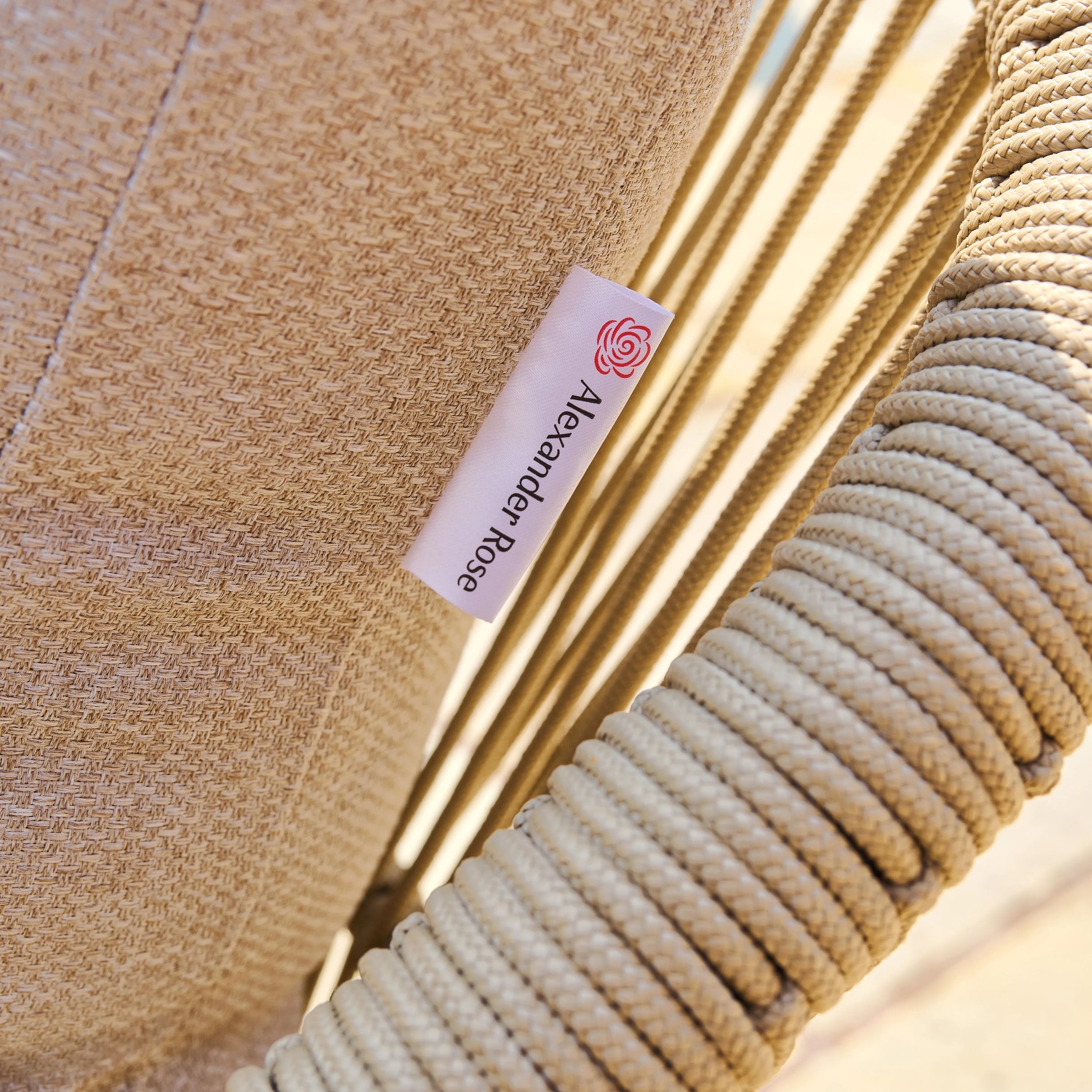 Close-up of a textured beige fabric with a brand label on a blurred background