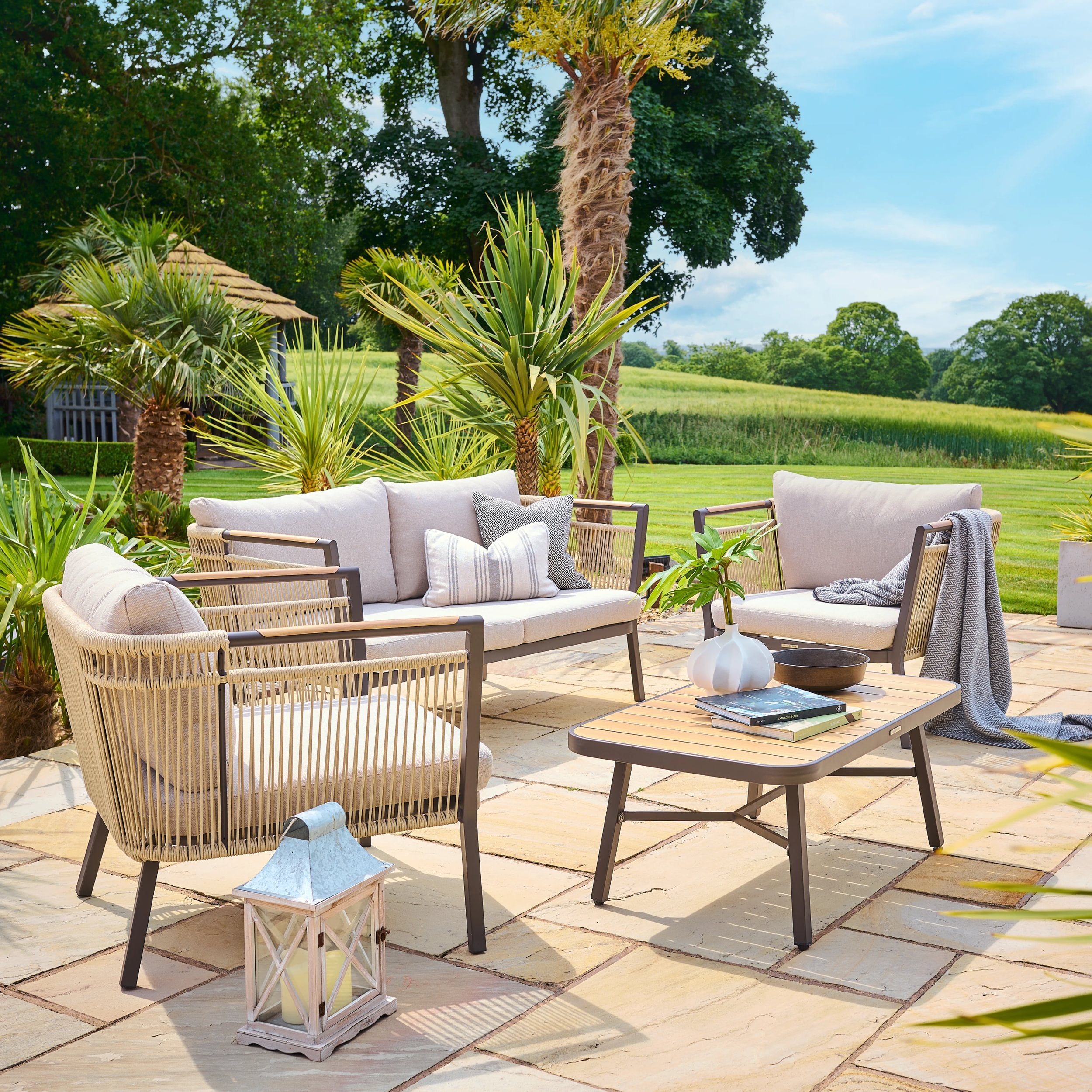 Outdoor patio set with furniture and decor in a garden setting