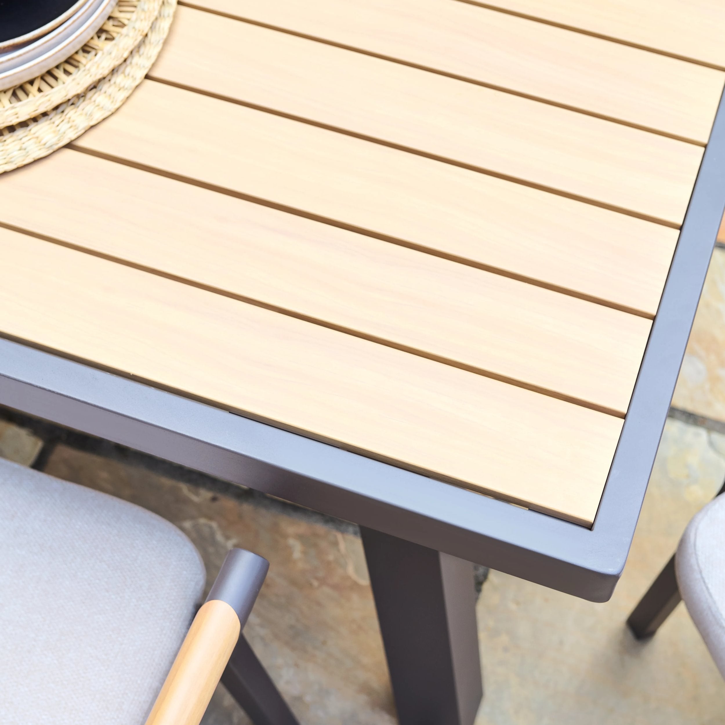 Wooden effect outdoor table with metal legs on a patio