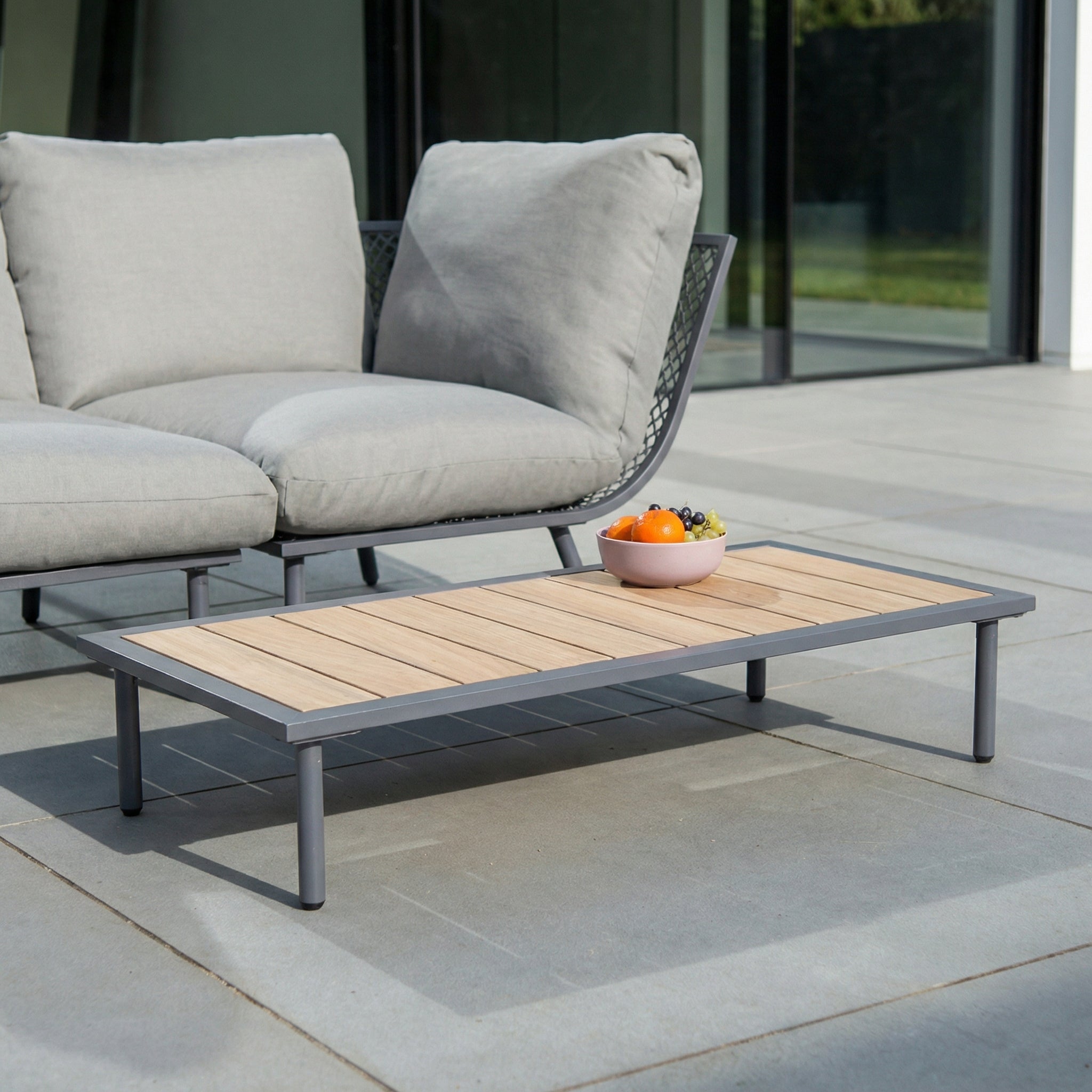 Outdoor furniture set with a sofa and coffee table on a patio