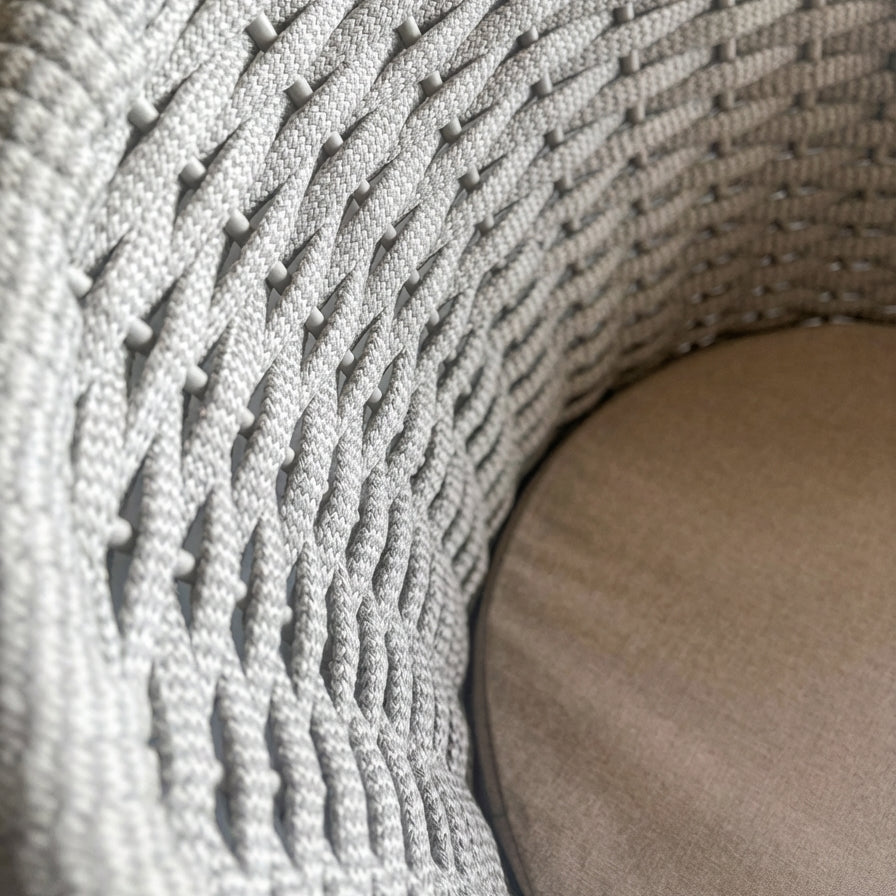 Close-up of the beige rope weave material used on the Cordial chair, showing its contrasting texture and detailing as well as a close up of the oat cushion use on the chair seat.