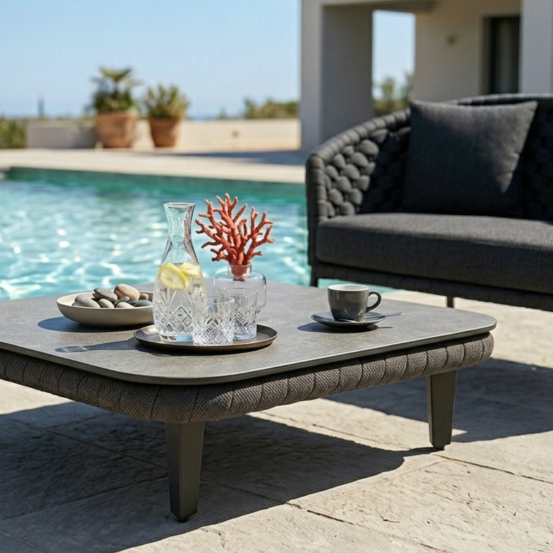 Outdoor rope patio set with coffee table and sofa by a pool