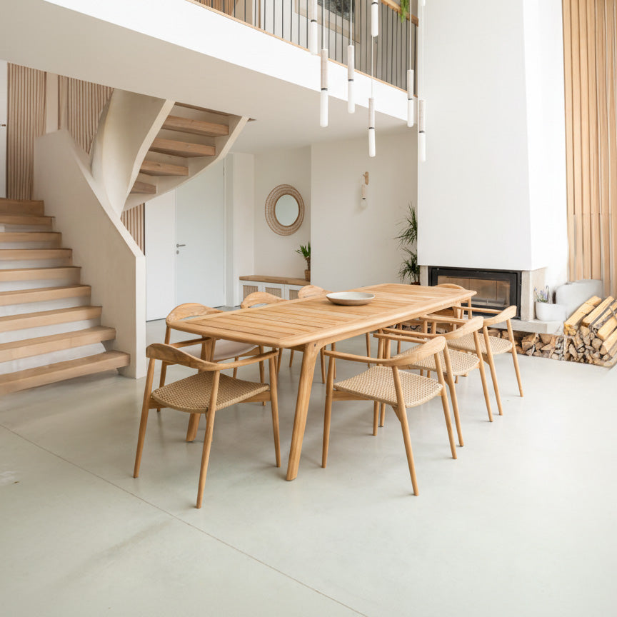 Modern dining area with wooden table and chairs in a home interior.