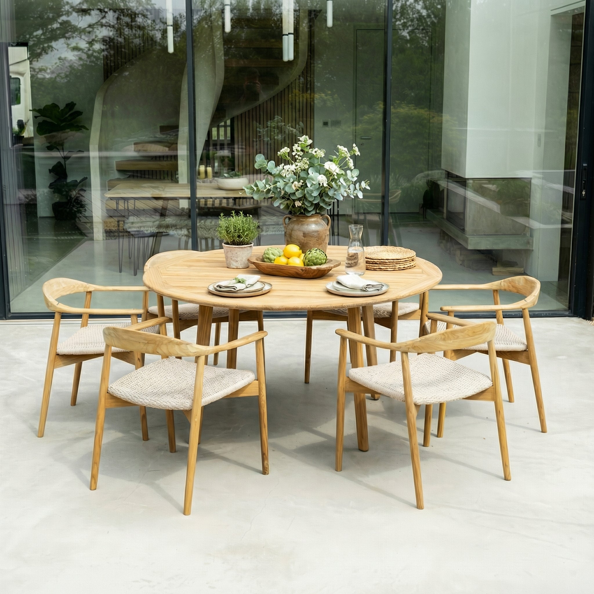 Teak dining table set with chairs in a modern indoor setting