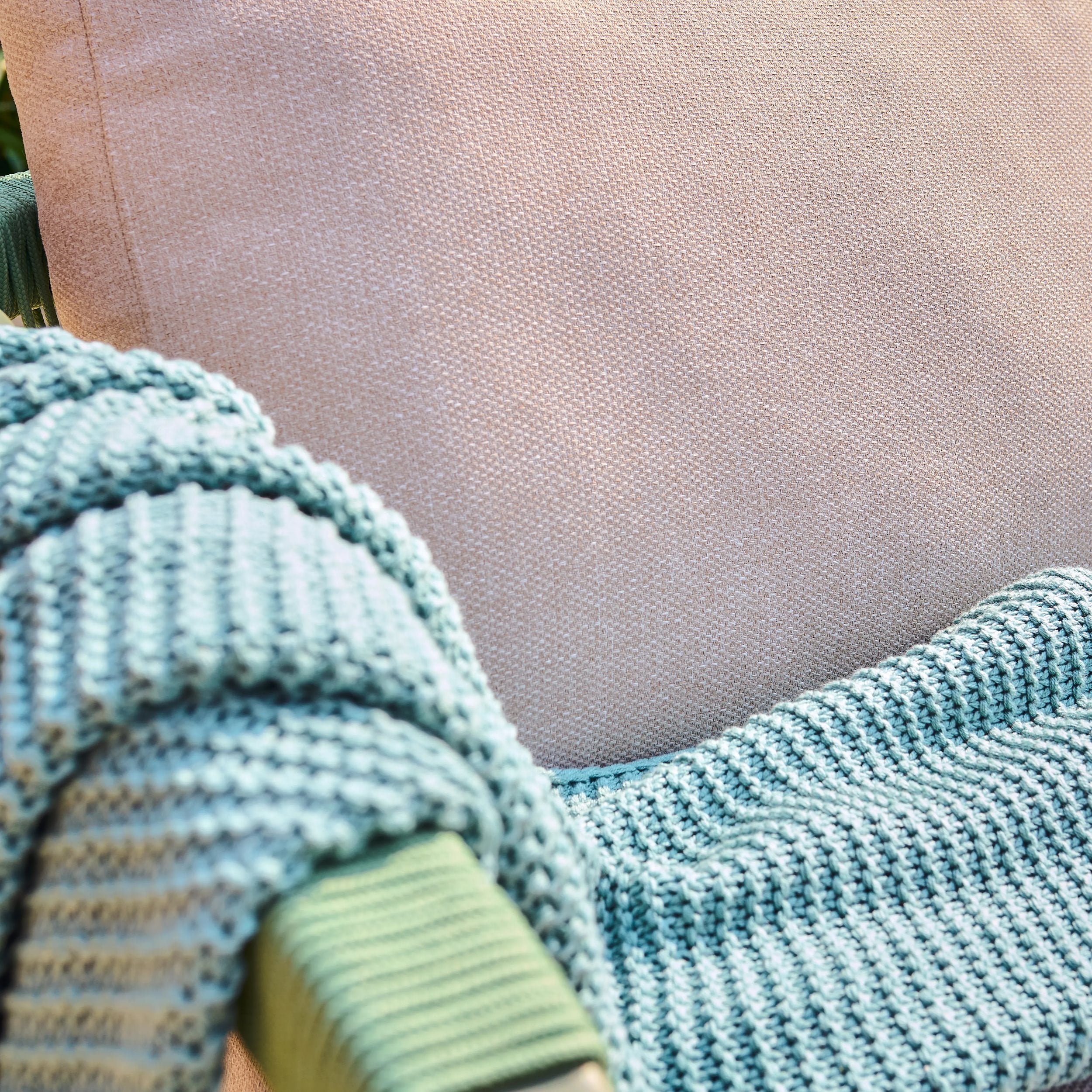 Close-up of a textured blue blanket draped over a surface.