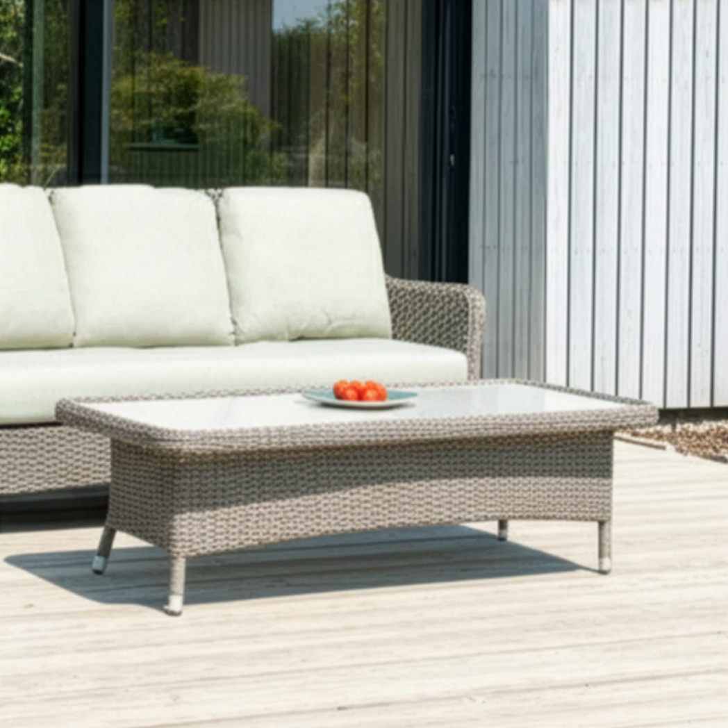 Outdoor furniture set with a sofa and coffee table on a wooden deck.