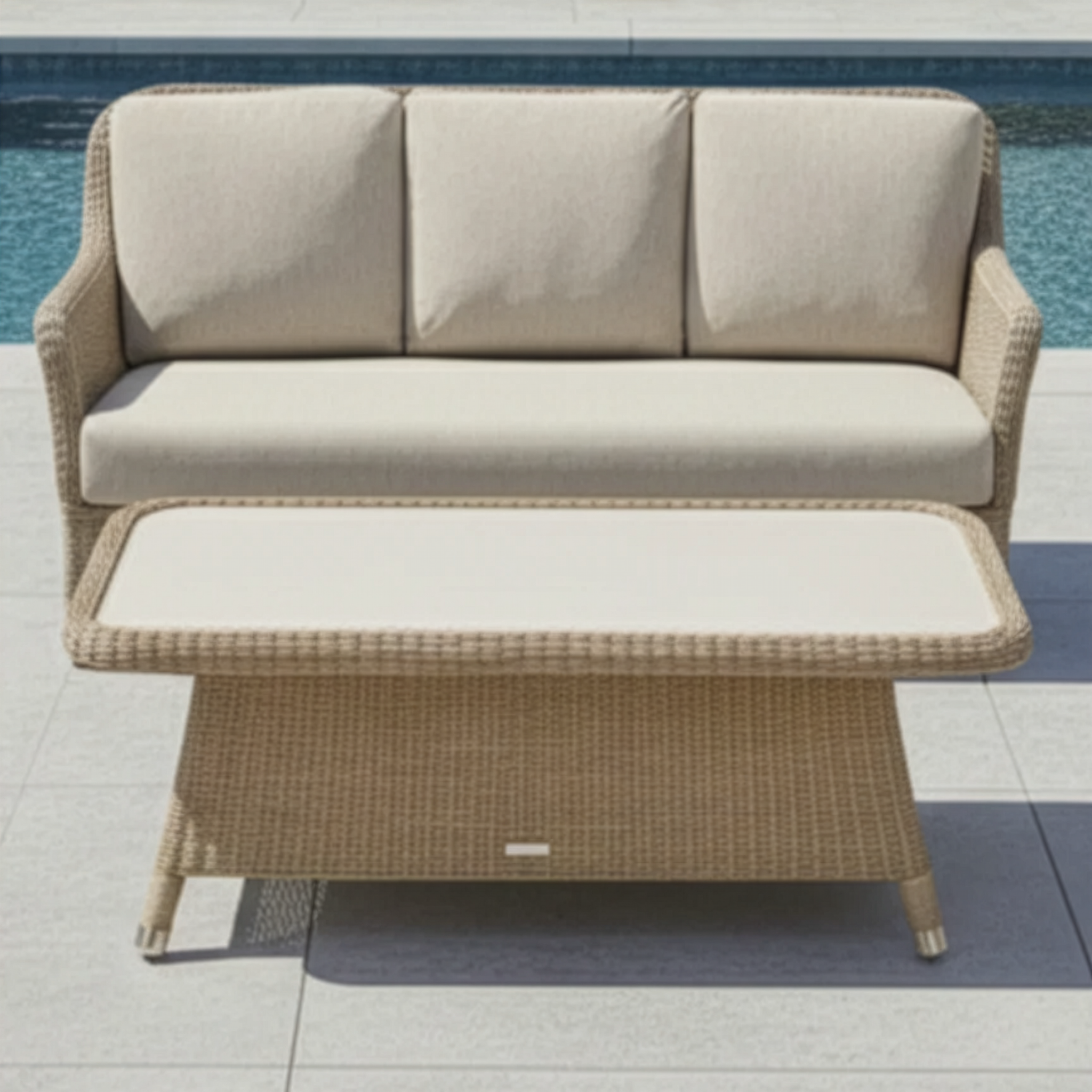 Beige outdoor sofa with matching table by a pool