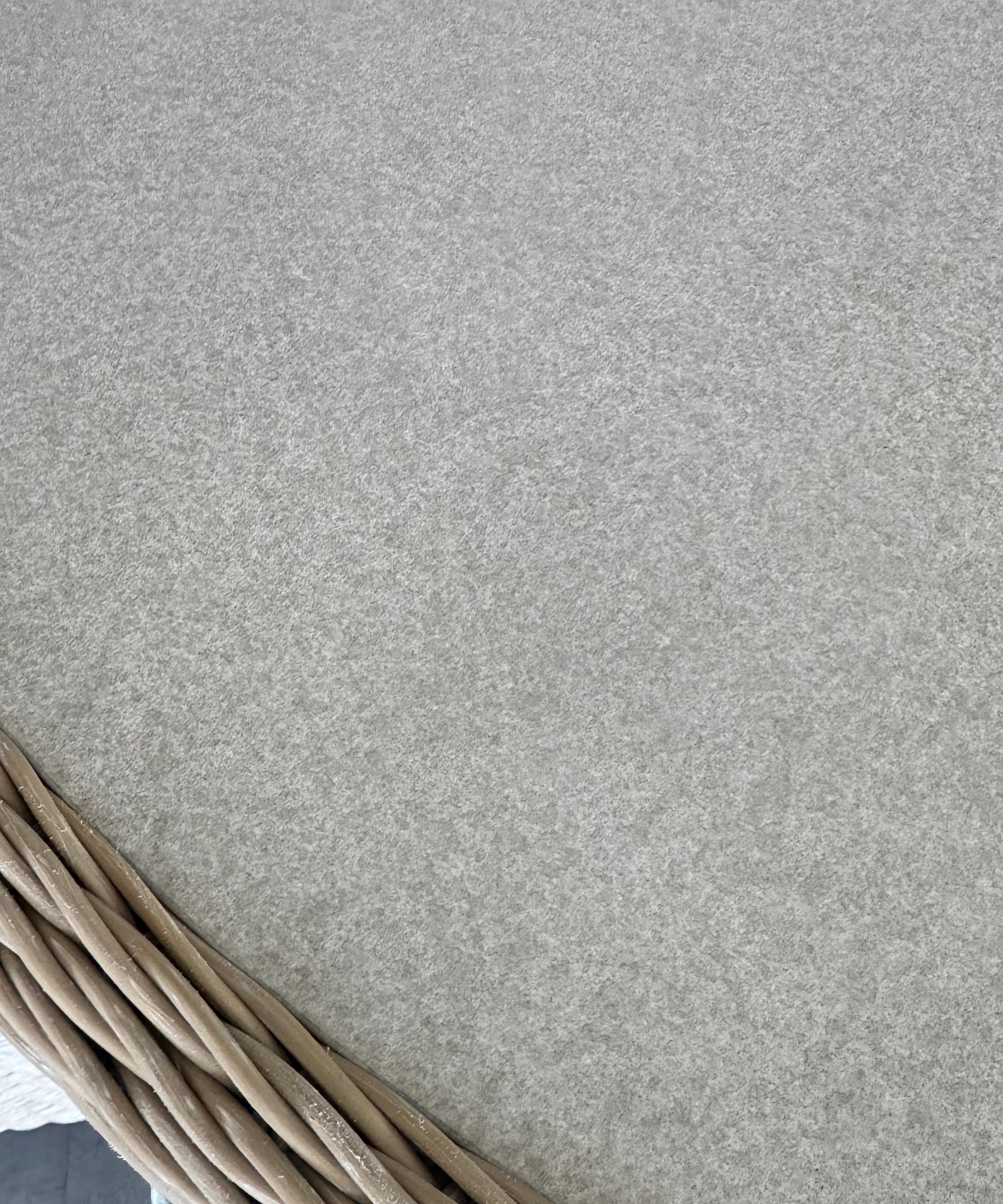 close up of rattan table edge in light grey