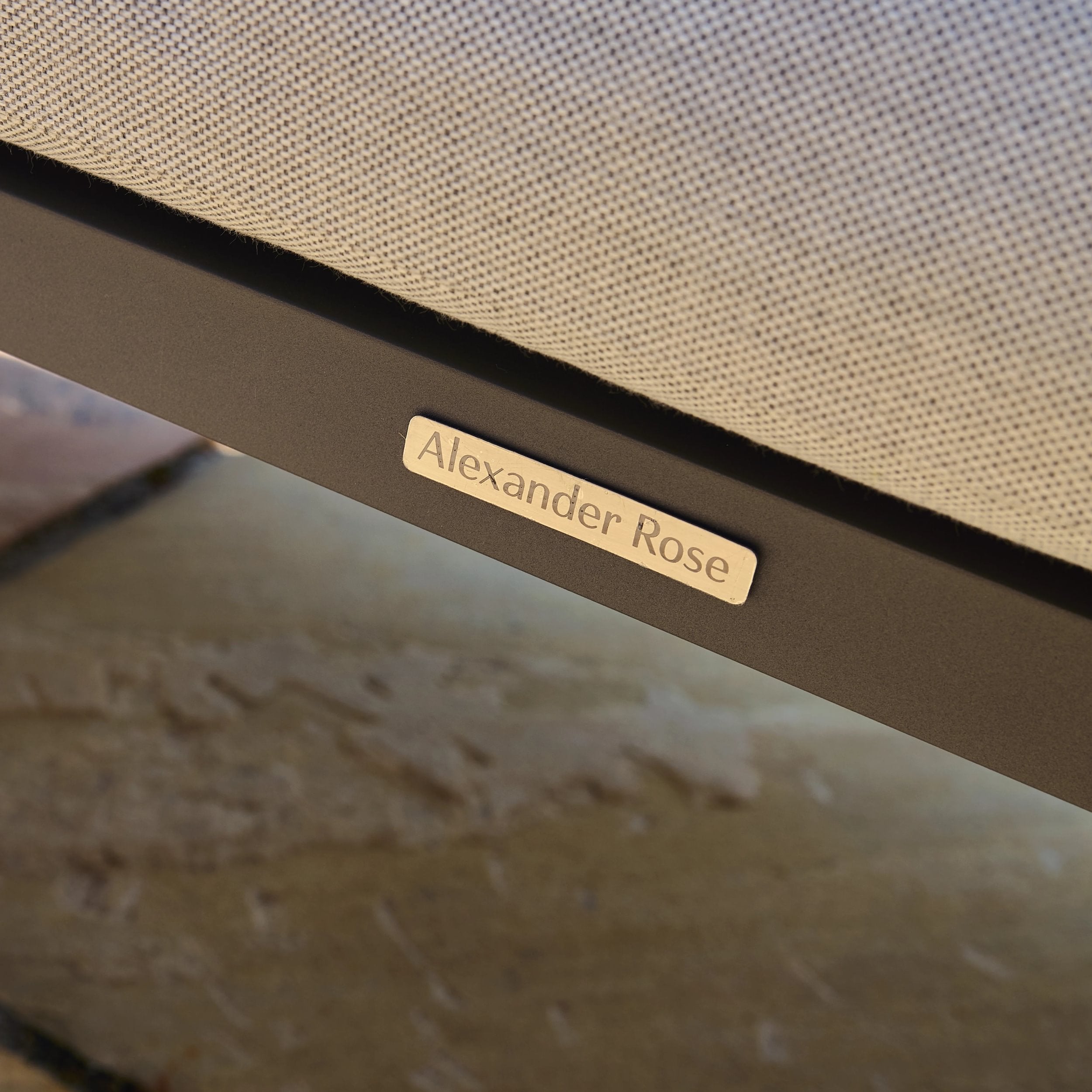 Close-up of a 'Alexander Rose' branded product on a textured surface