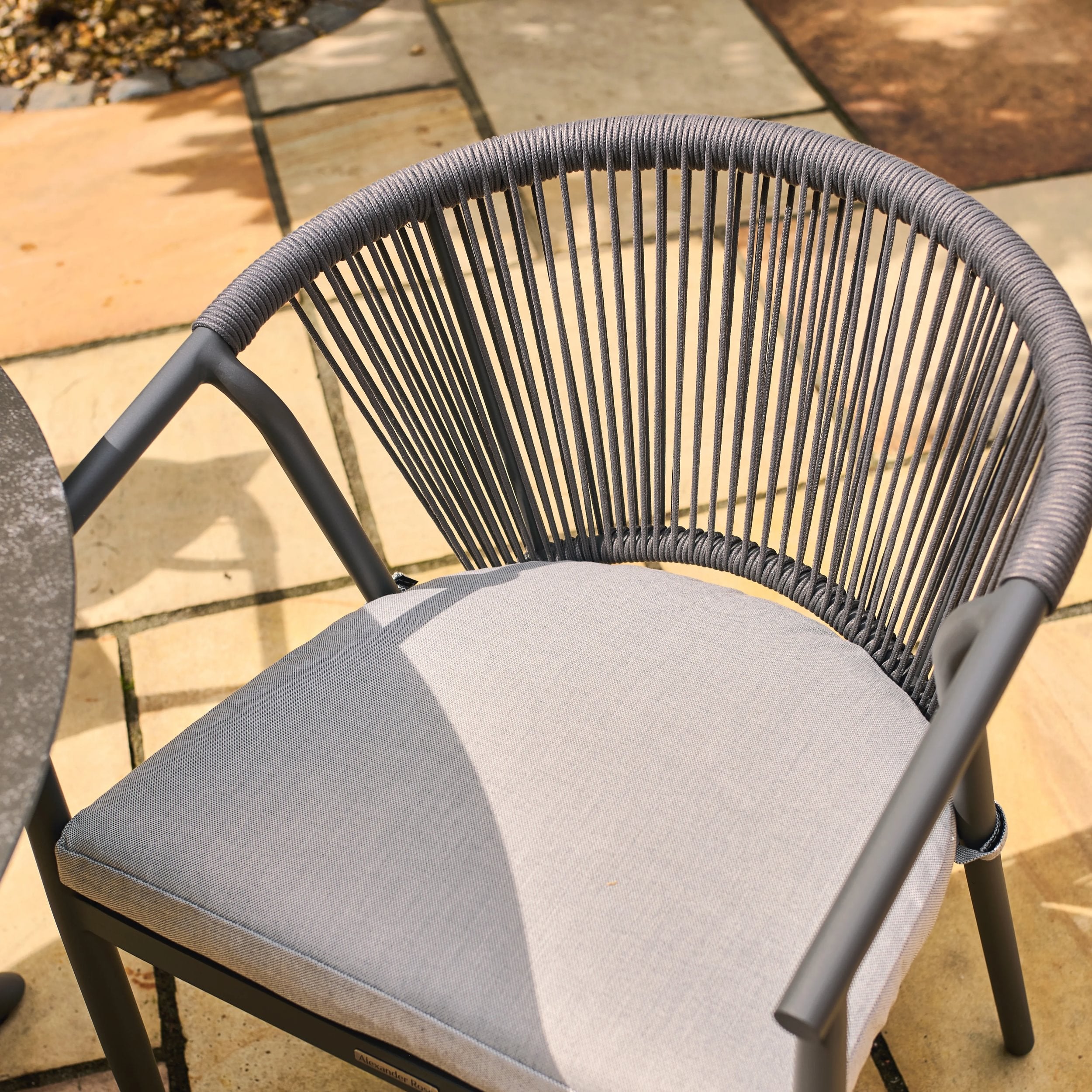 Kyoto grey rope chair with cushion on a patio