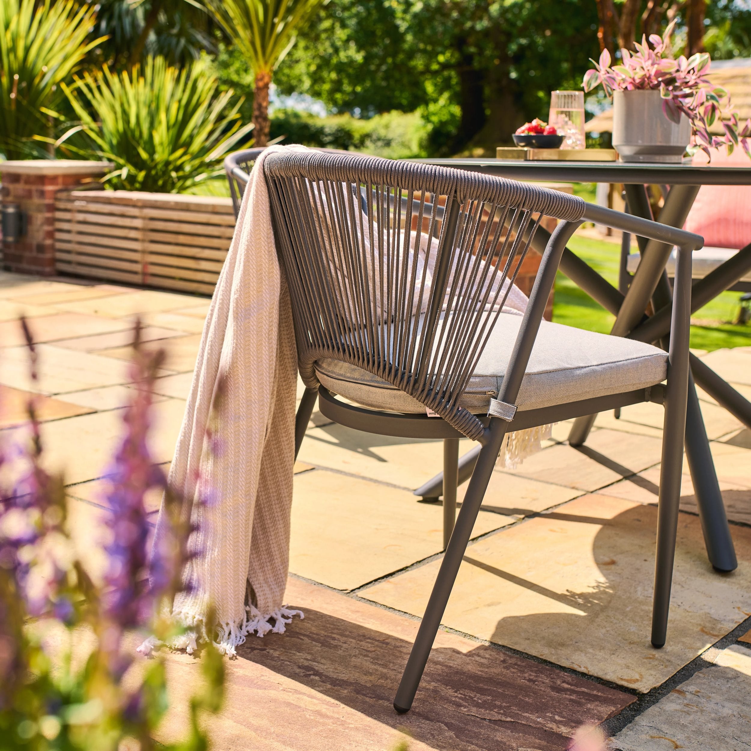 Kyoto outdoor patio chair with a blanket on a wooden deck with garden view