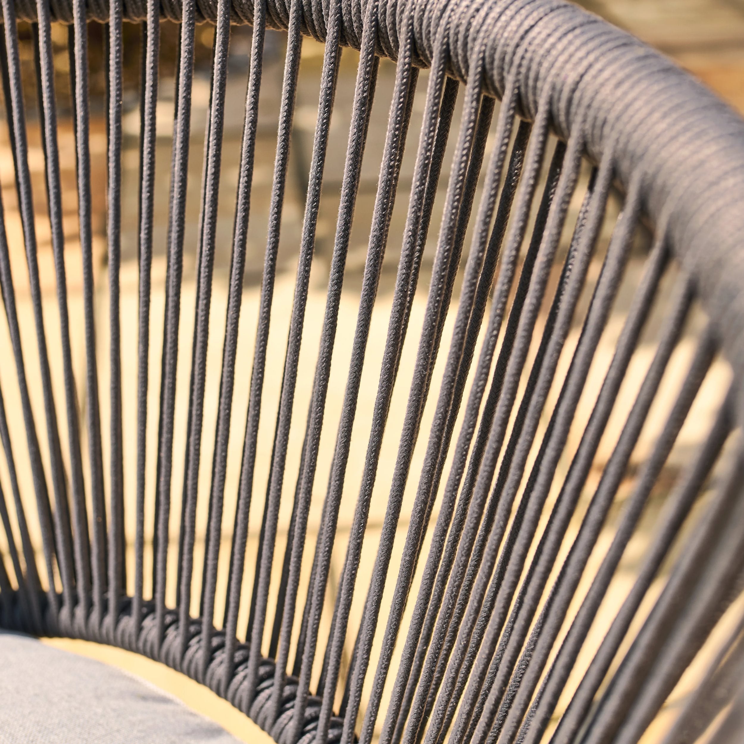 Close-up of a weave chair with grey ropes.