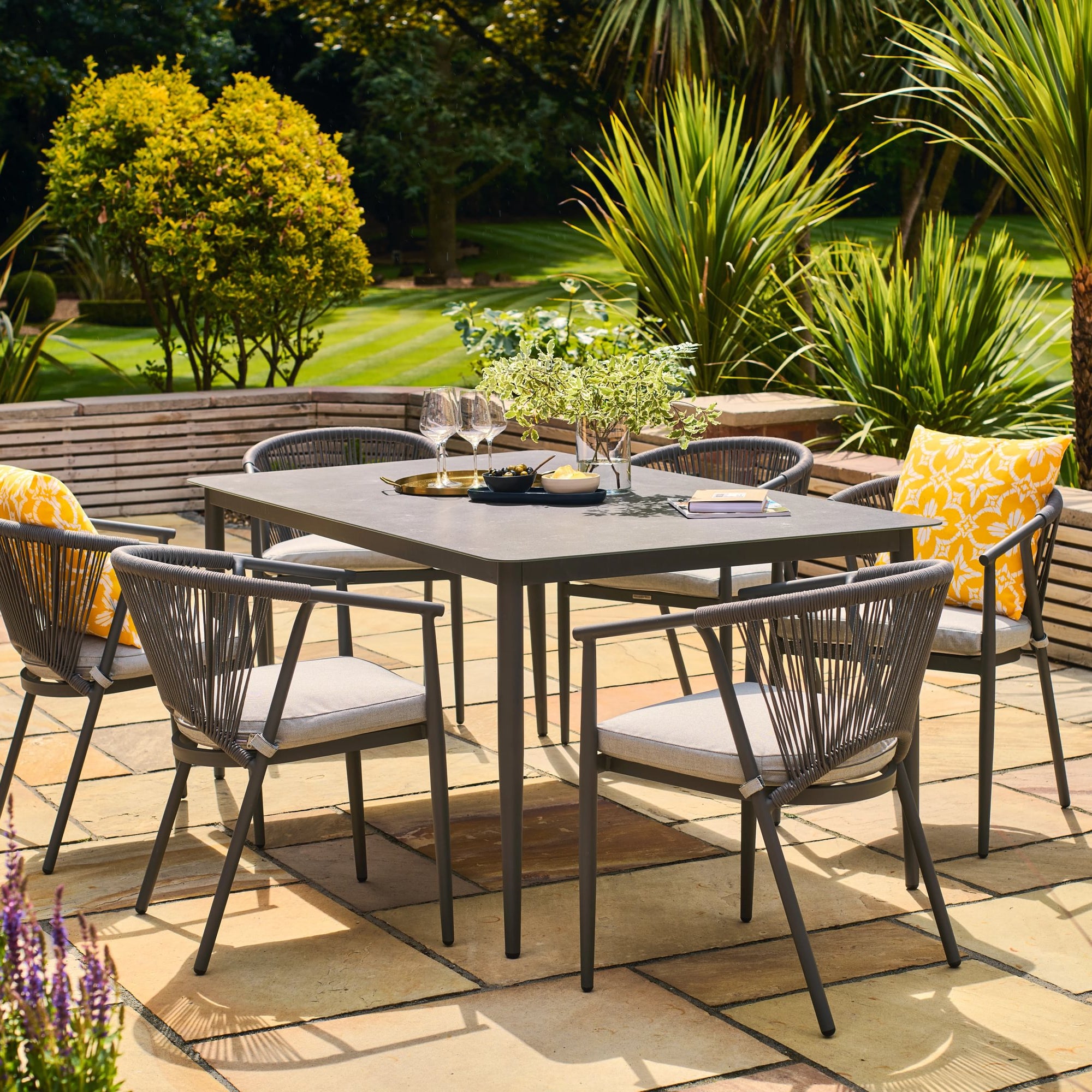 Outdoor patio set with table and chairs on a sunny day