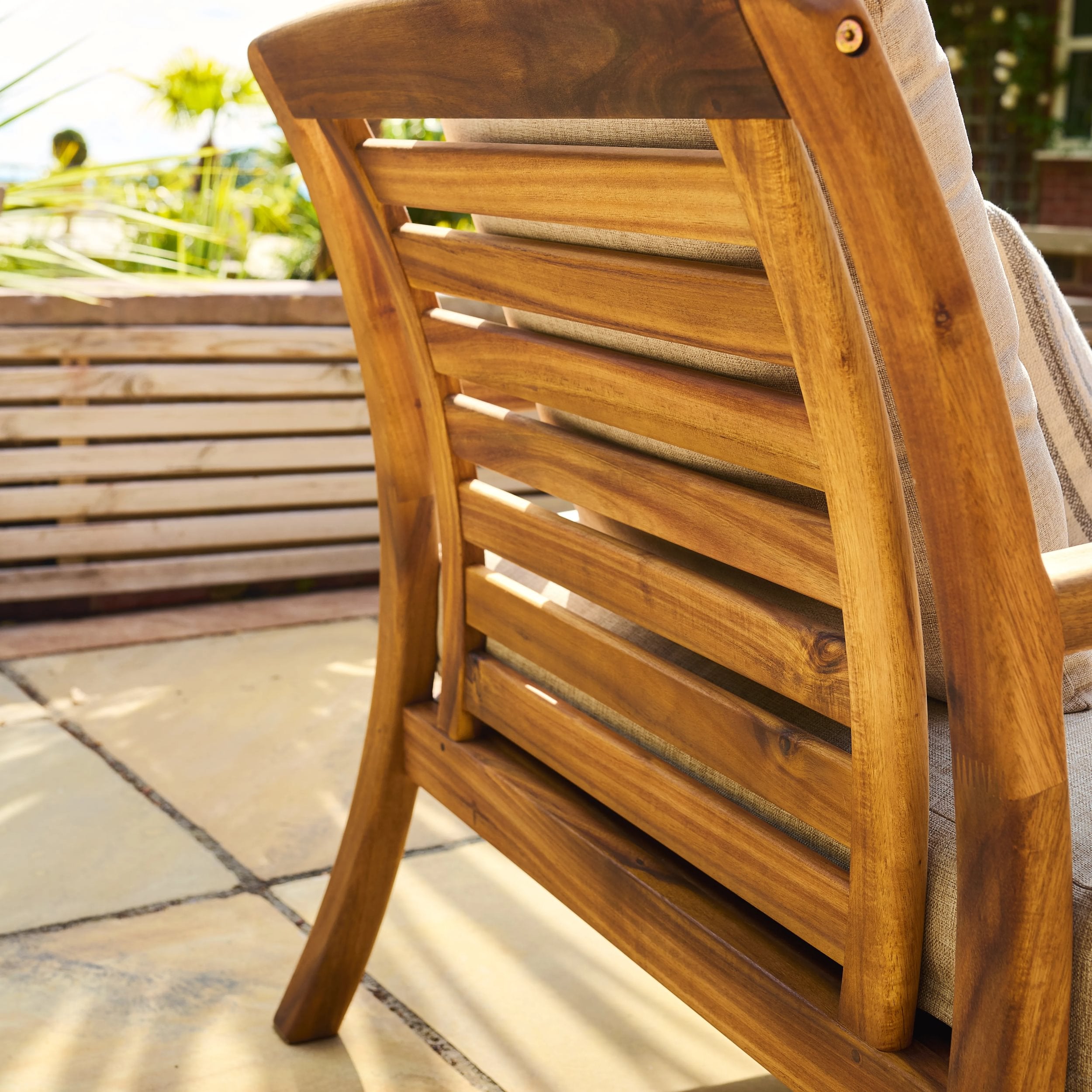 Wooden chair with slatted back on a patio