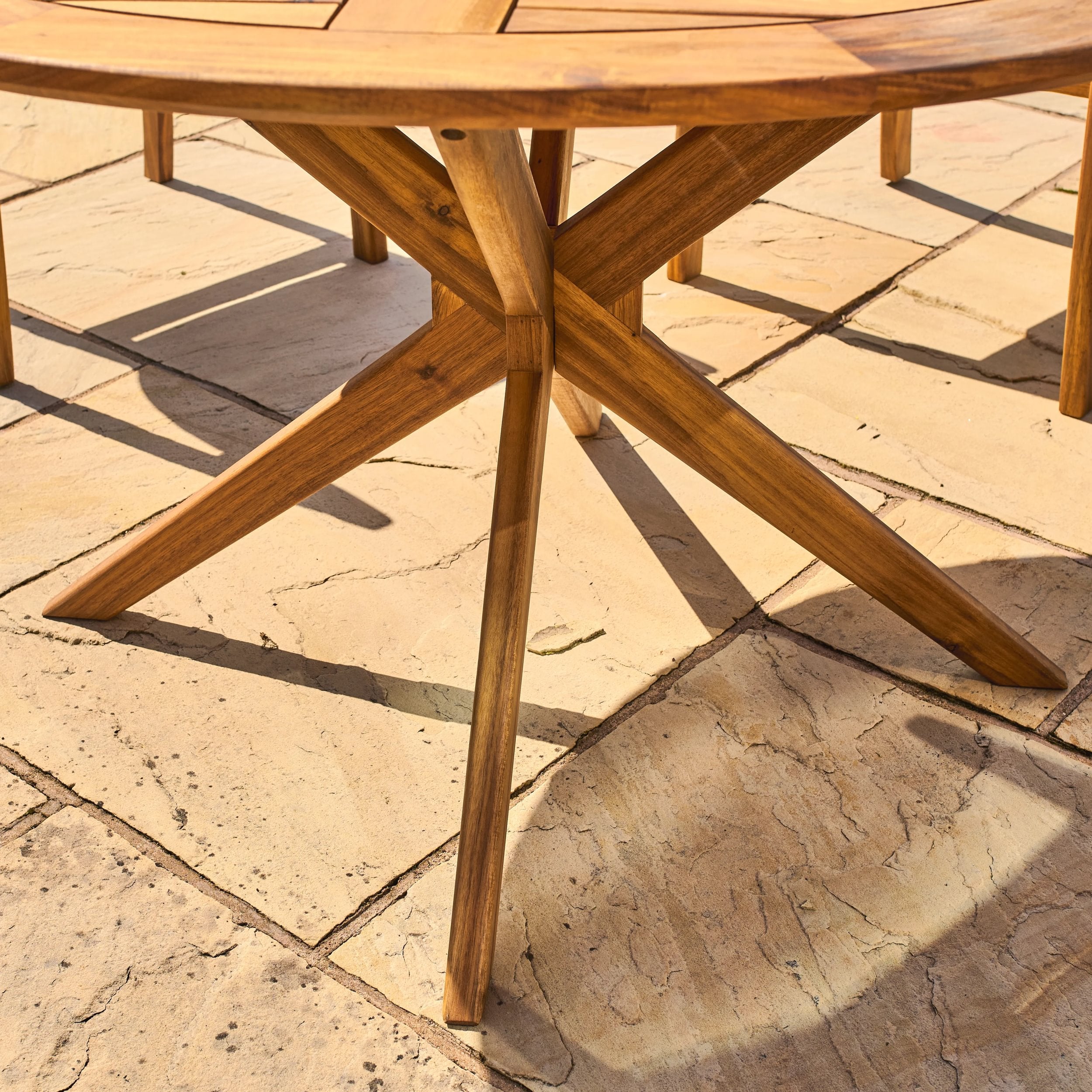 Wooden outdoor table on a stone patio