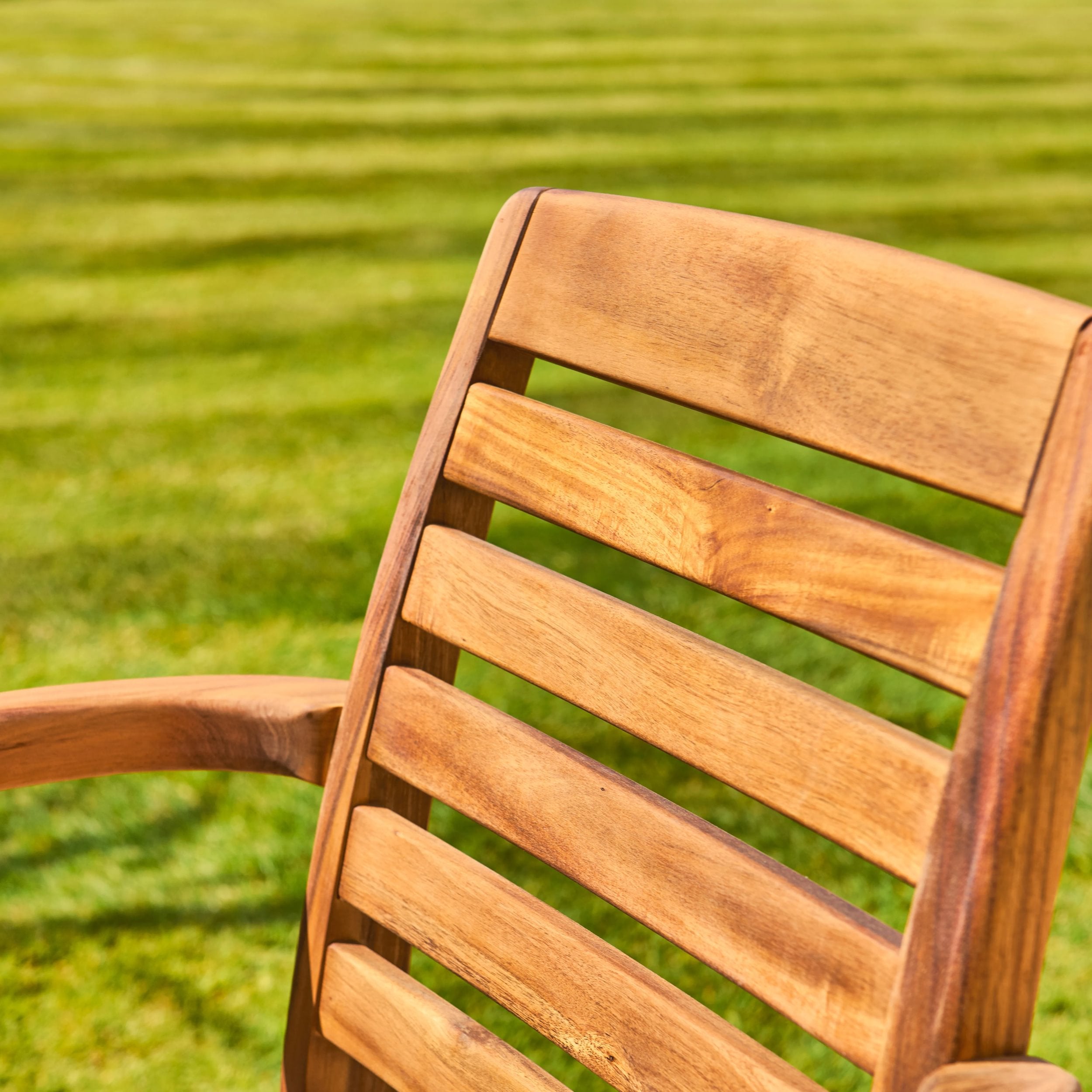 Wooden chair with a blurred green grass background
