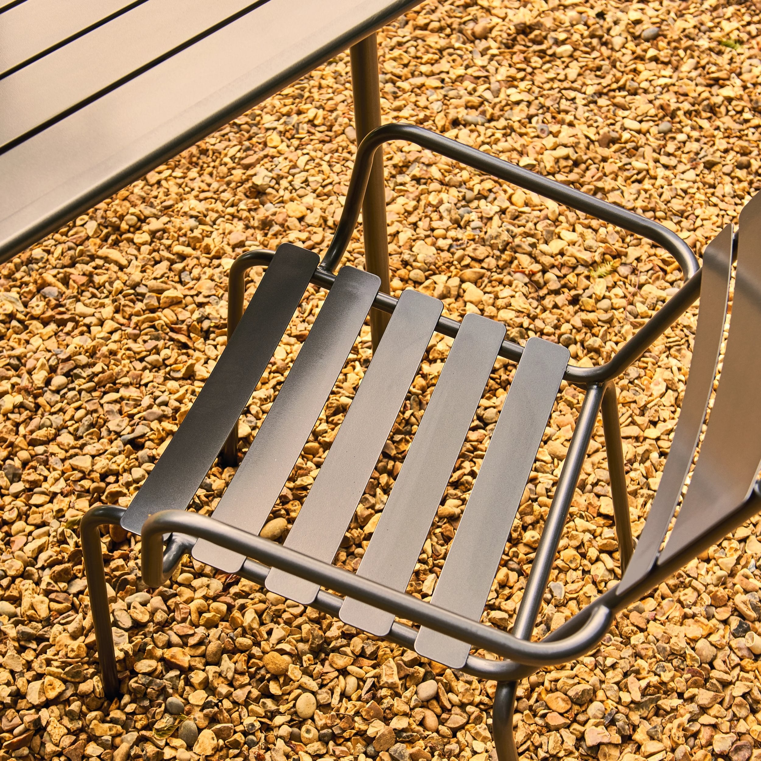 Metal chair on a gravel surface