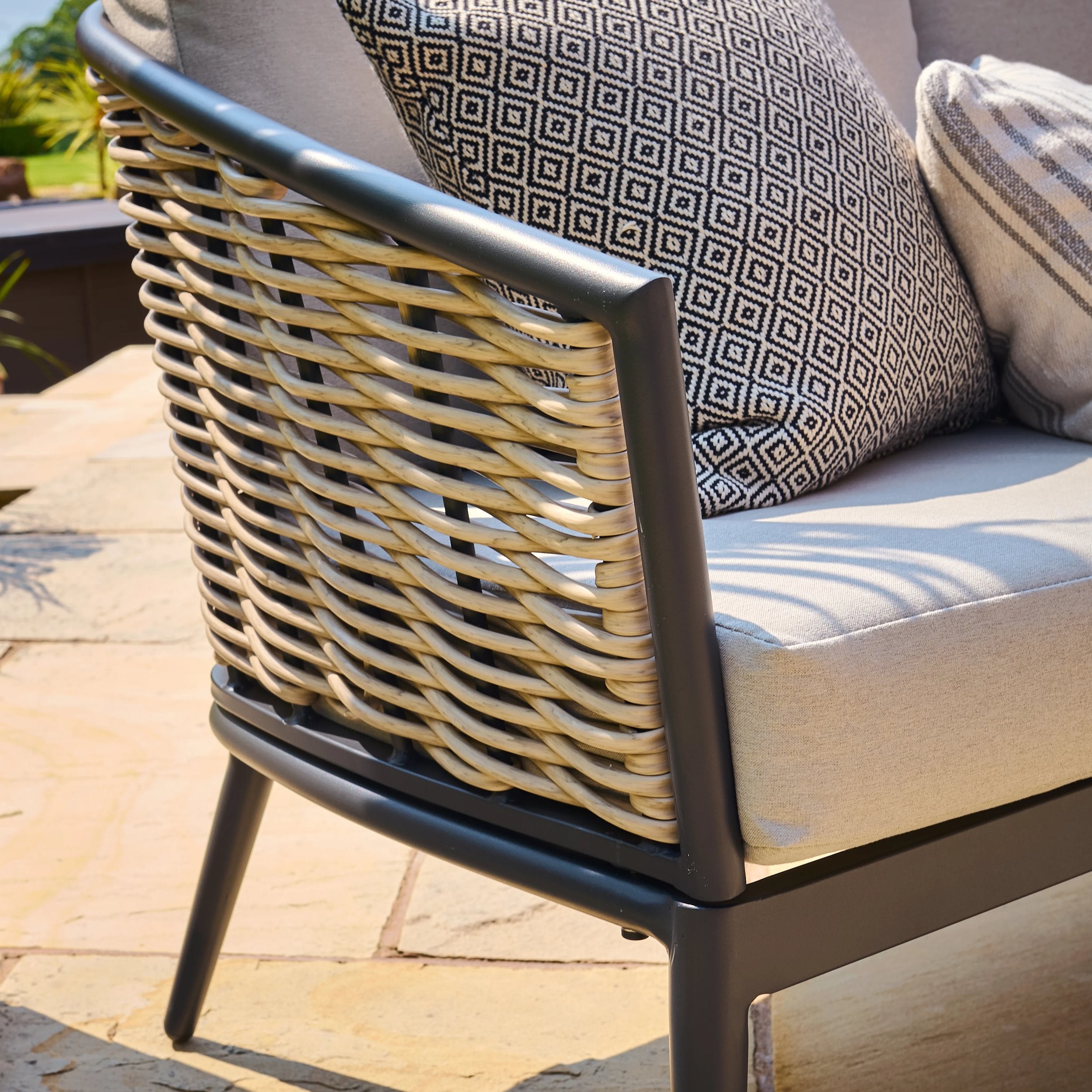 Rattan chair with cushions on a patio