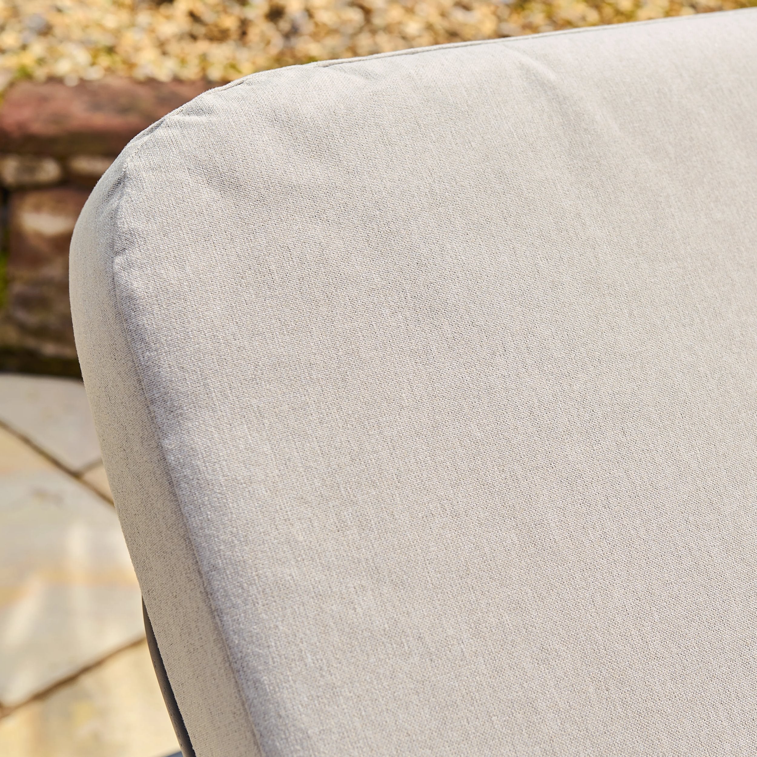 Close-up of a light grey cushion on a sun lounger with a blurred background