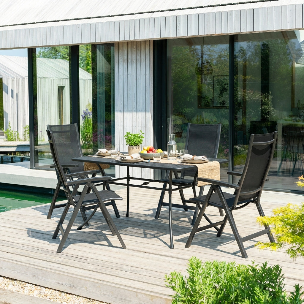 Outdoor patio set with table and chairs on a wooden deck.