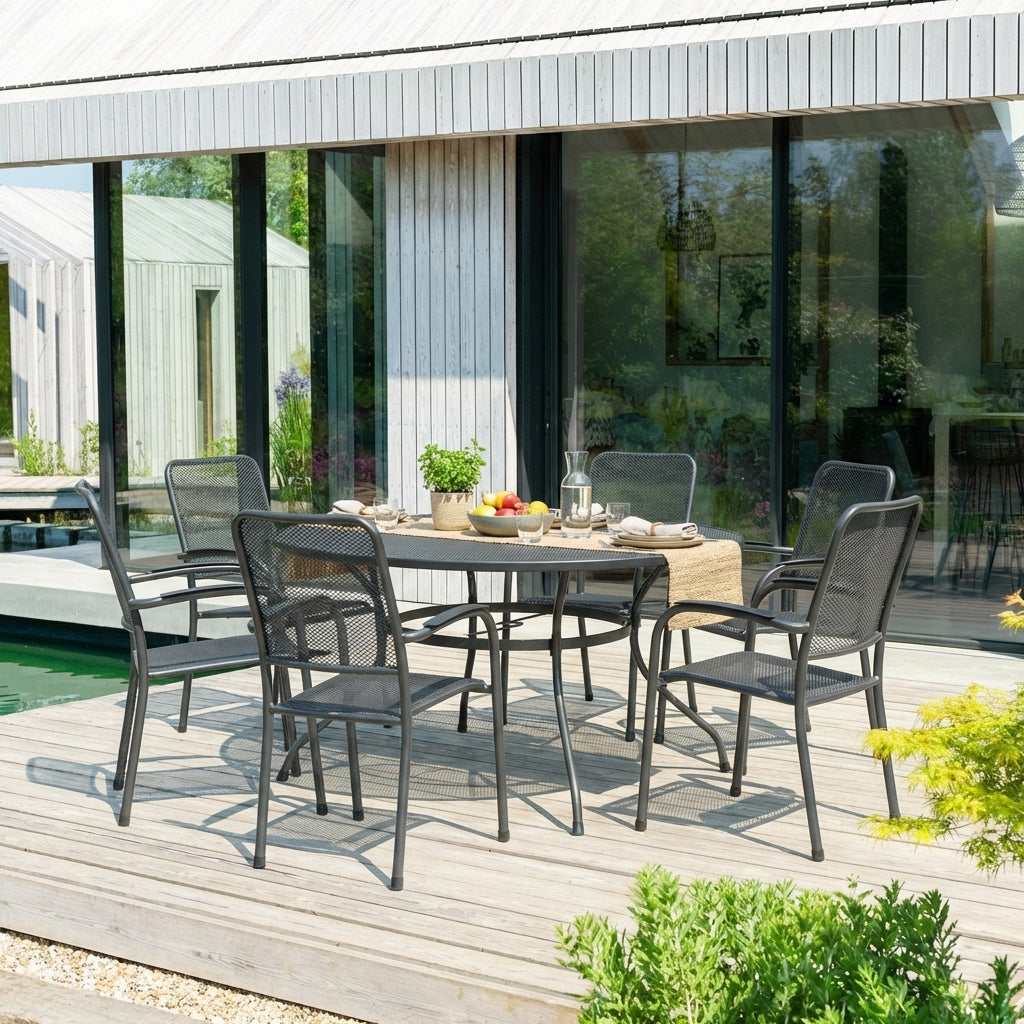 Outdoor dining set on a wooden deck with a modern house in the background