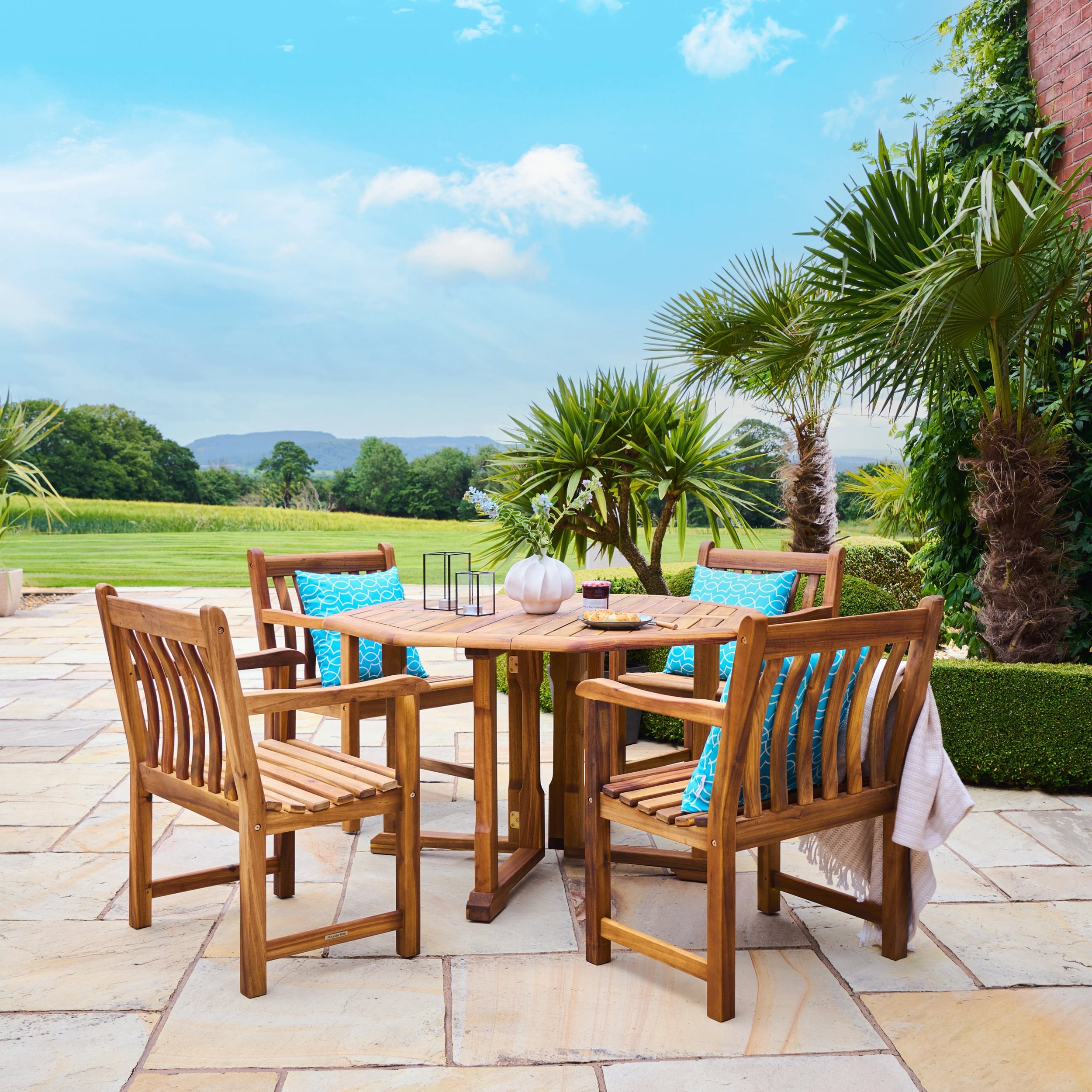 Wooden outdoor dining set with chairs and table in a garden setting