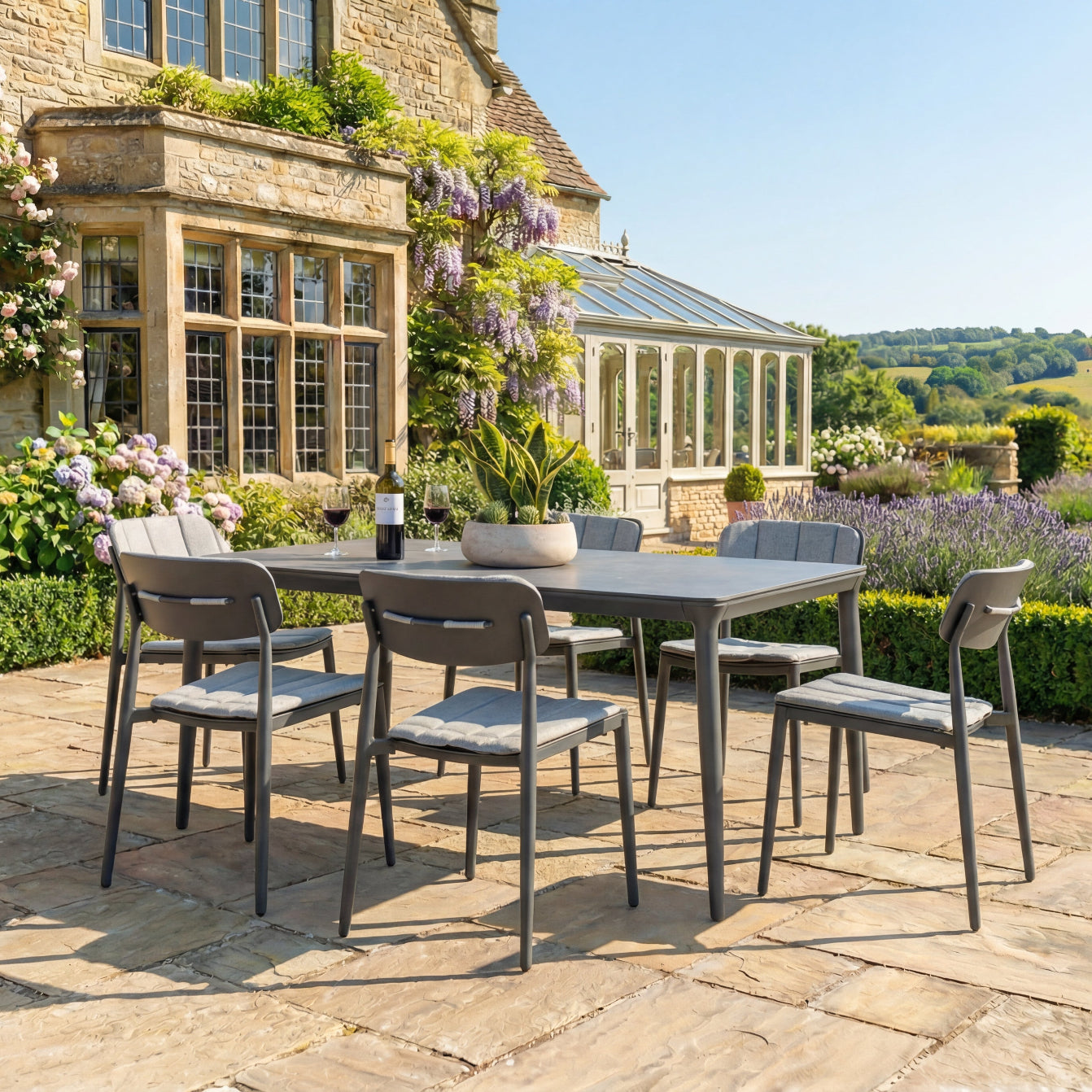 Outdoor patio set with table and chairs in a garden setting.
