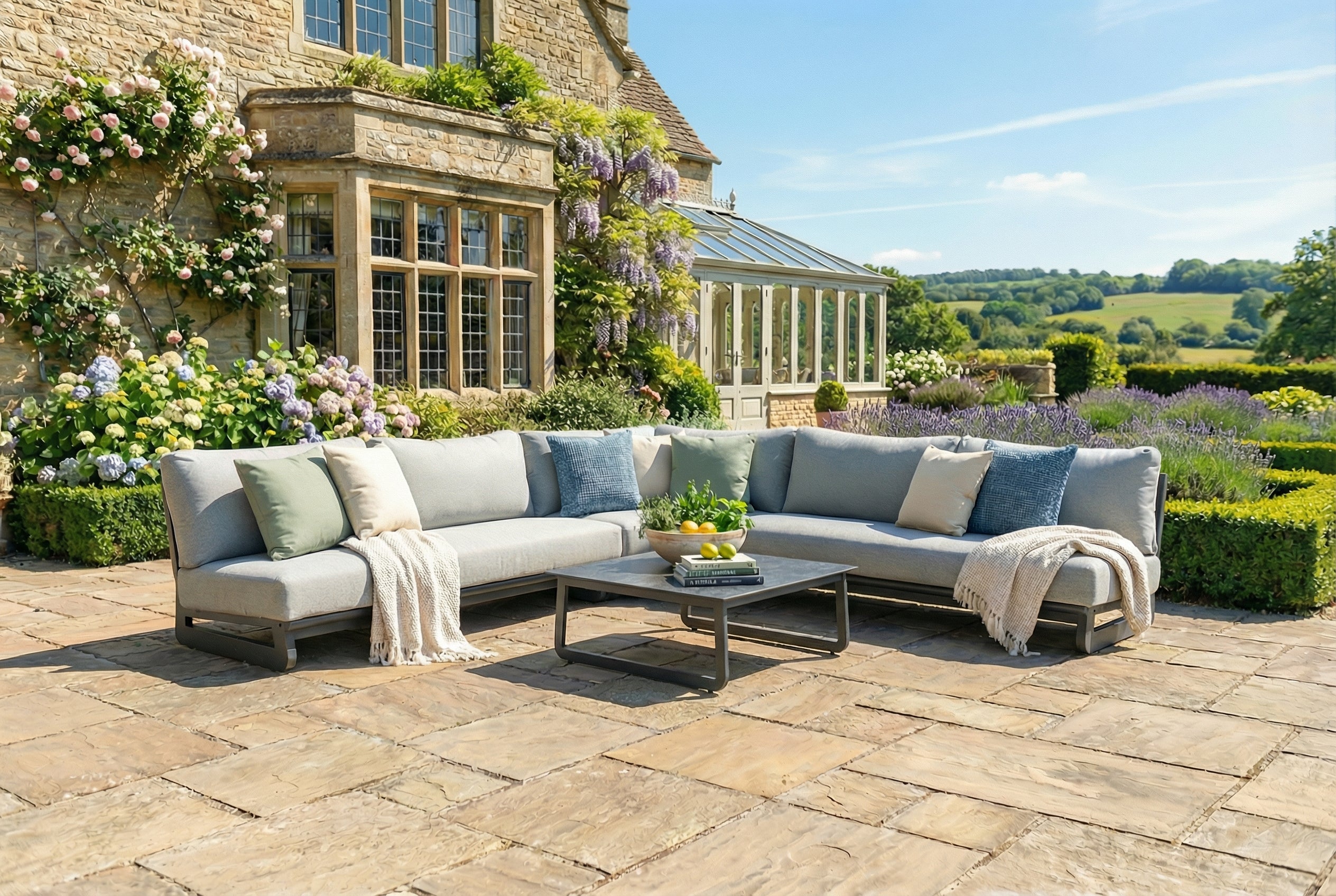 Outdoor patio with a sectional sofa, coffee table, and decorative elements in a garden setting.