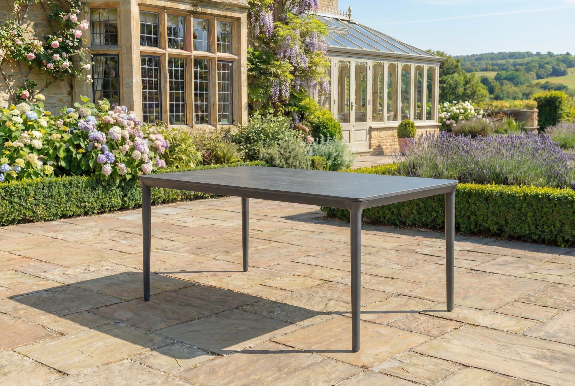 Garden table on a patio with a garden and building in the background