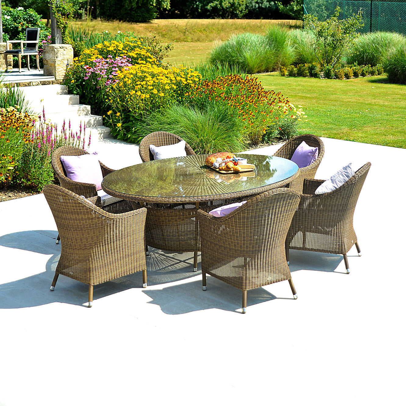 Alexander Rose San Marino circular garden table with rounded back arm chairs