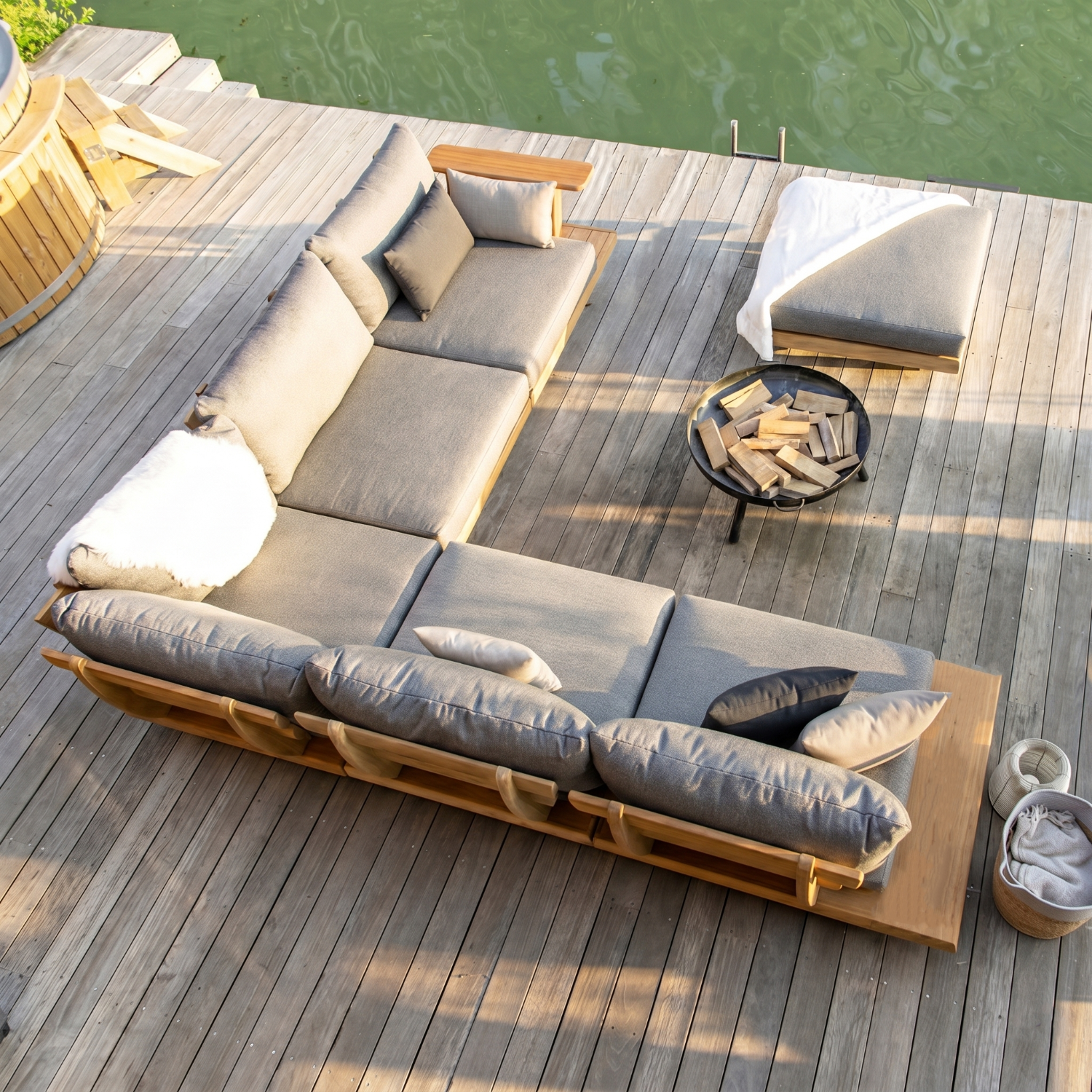 Outdoor sectional sofa on a wooden deck by a body of water