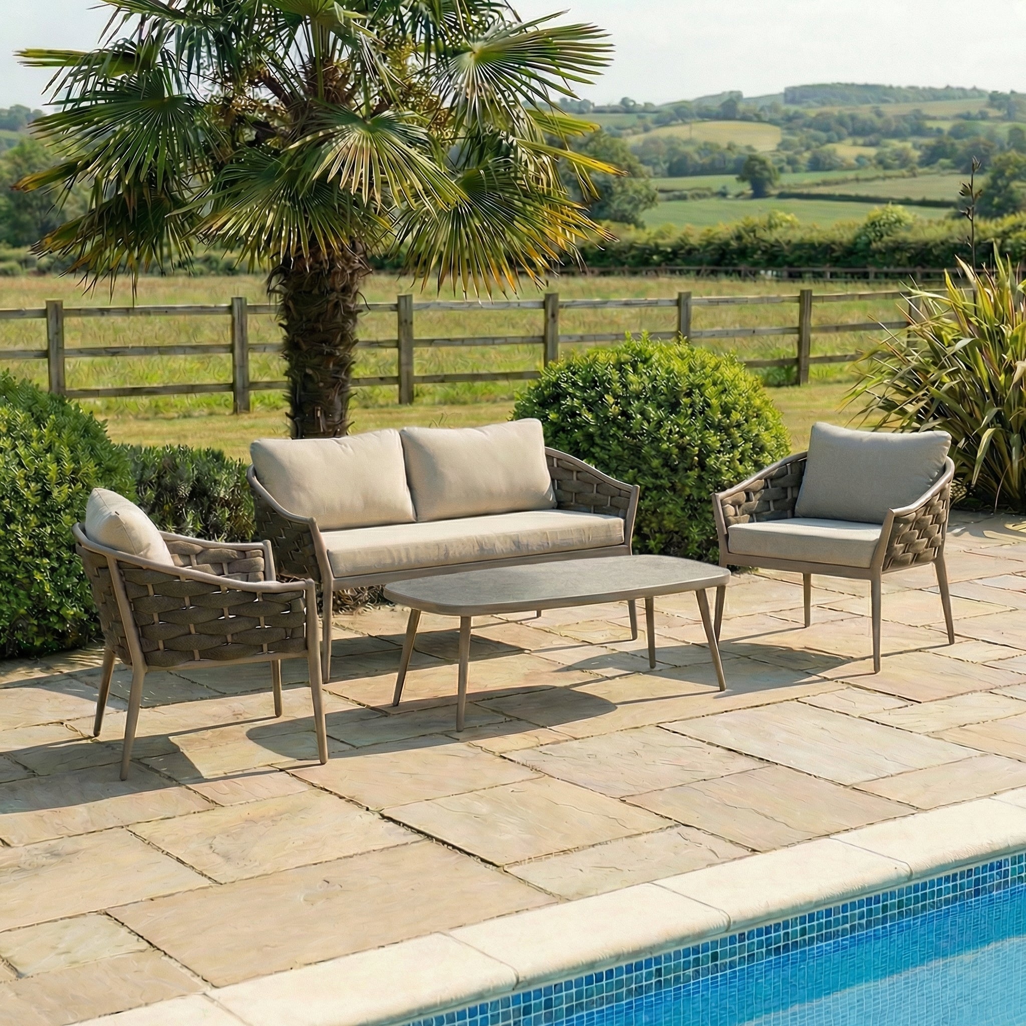 Sofa lounge set consisting of a 2-seater, lounge chairs and coffee table on a patio.