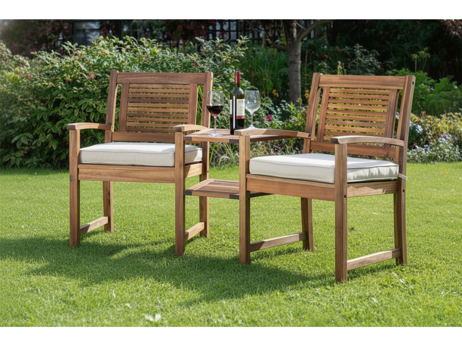 Two wooden chairs with white cushions on a grassy area, set against a garden background.