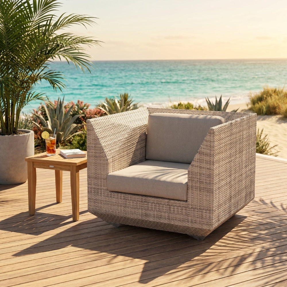 Beige wicker chair with cushions on a wooden deck by the ocean