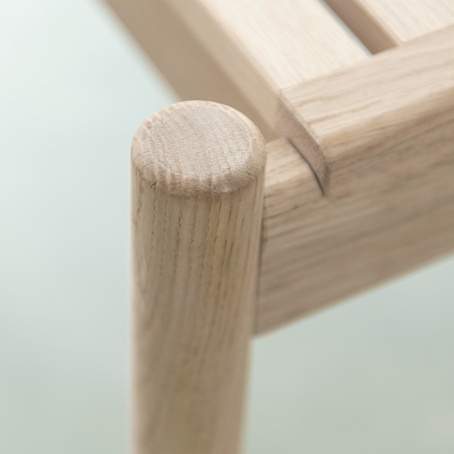 Close-up of the corner of Trak indoor bench in European oak